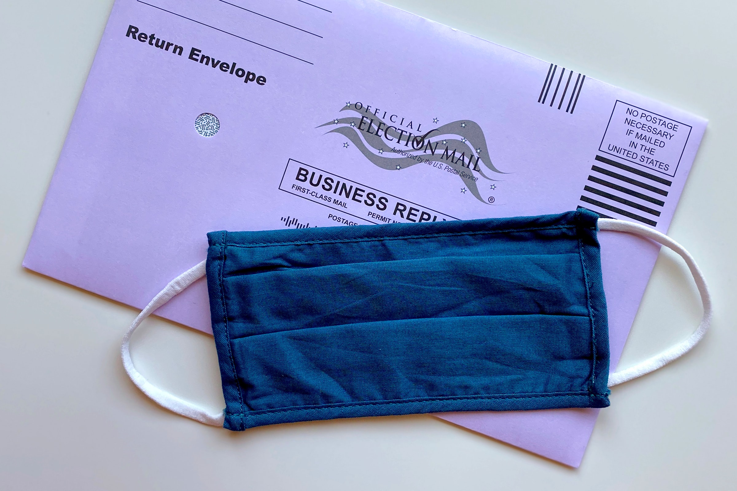 A facemask onto of a mail-in ballot
