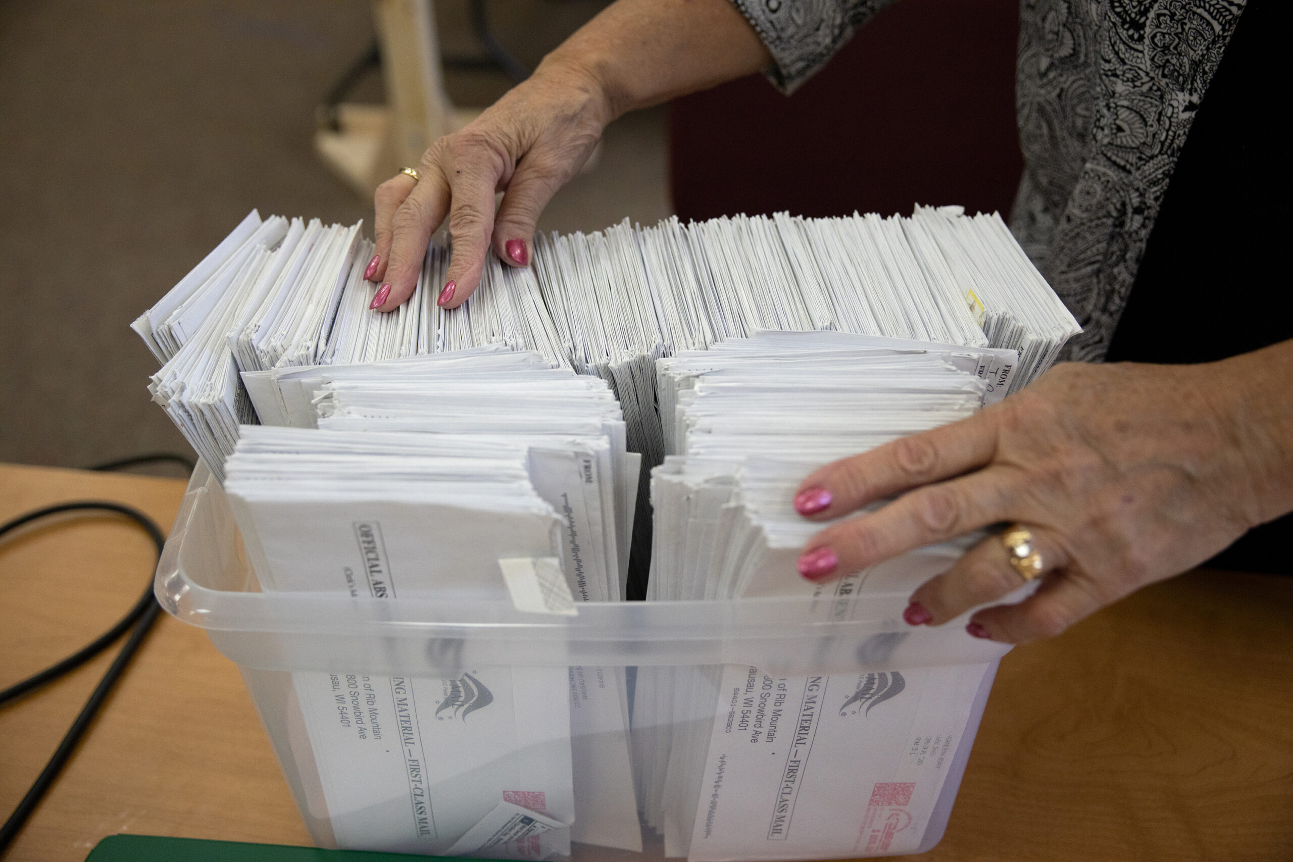 election inspector alphabetizes and organizes absentee ballots