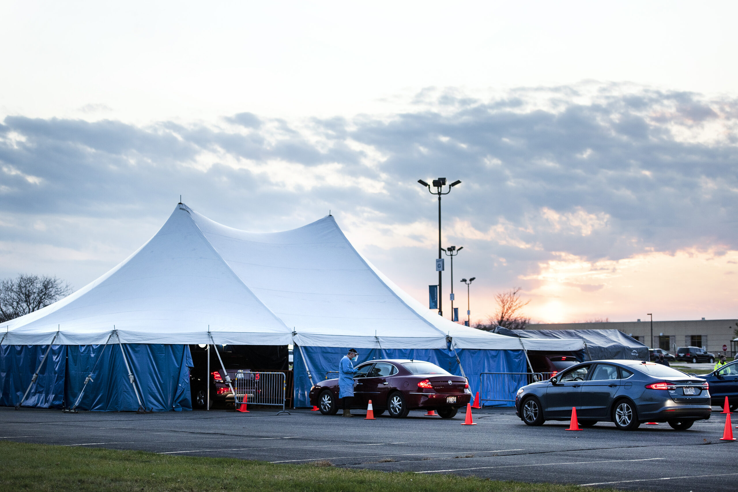 A tent is set up for vehicles to drive through and receive COVID-19 testing