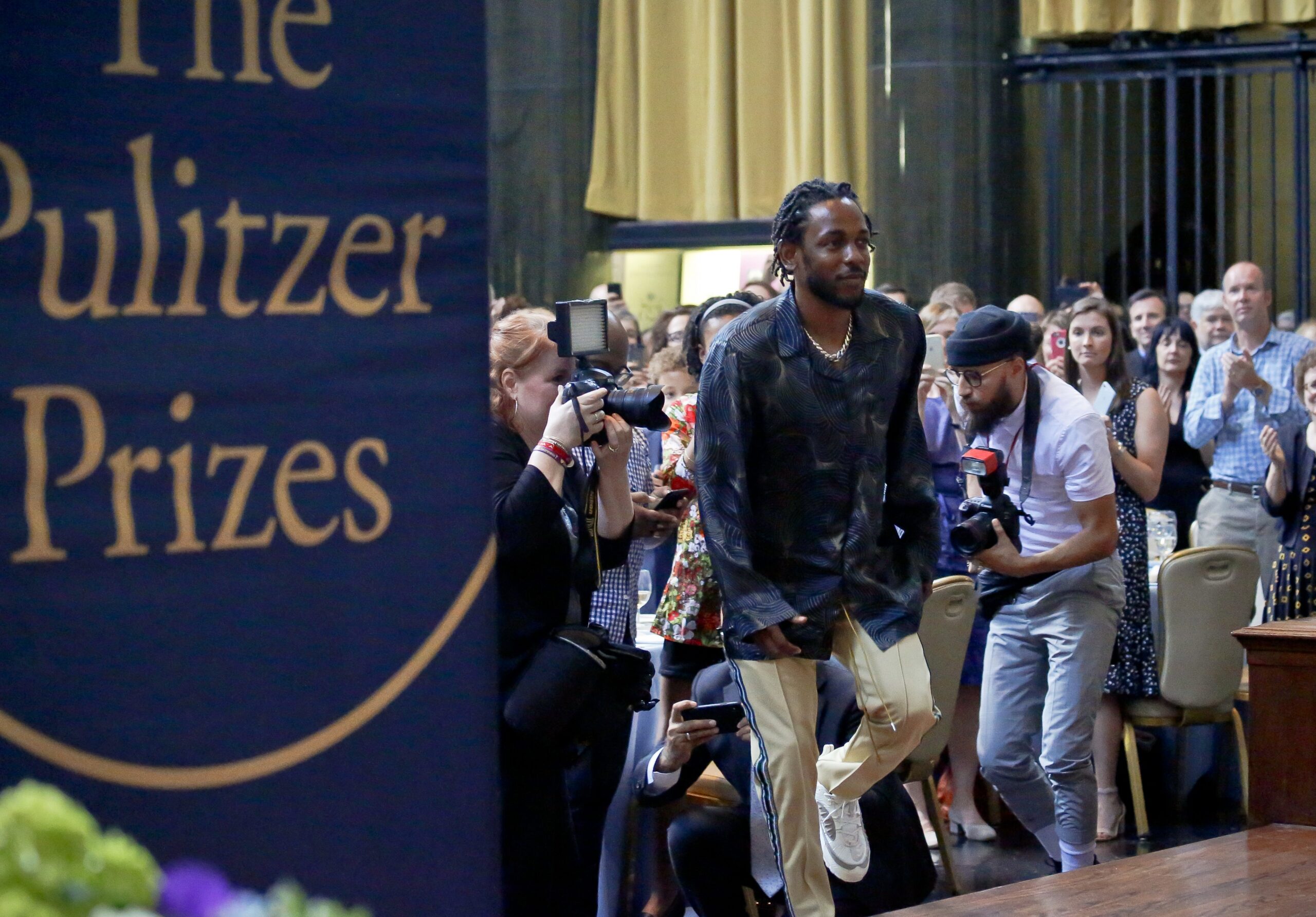 Pulitzer Prize winner for music Kendrick Lamar walks onto the stage to accept his award