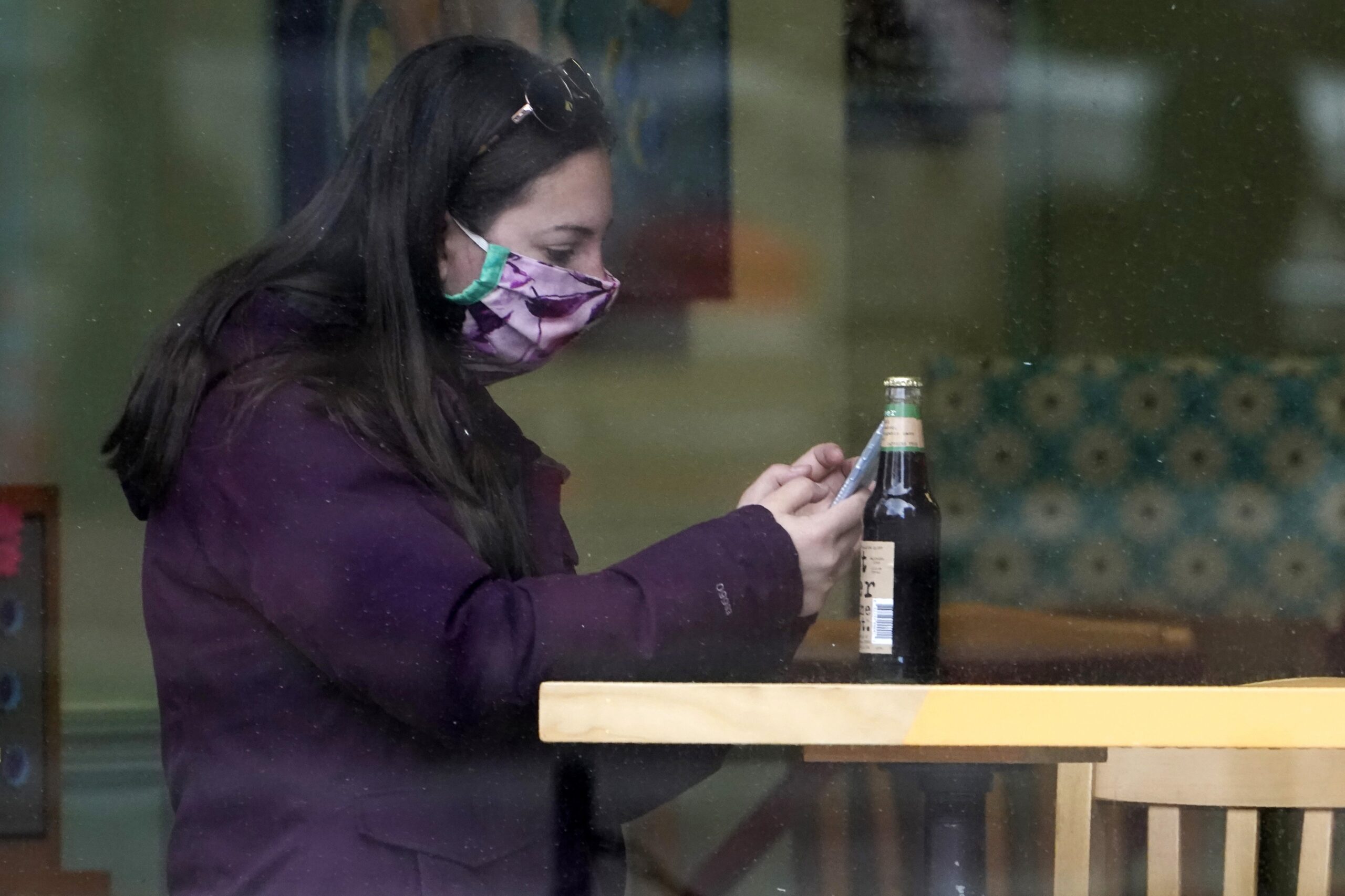 person wearing a facemask while dining indoors
