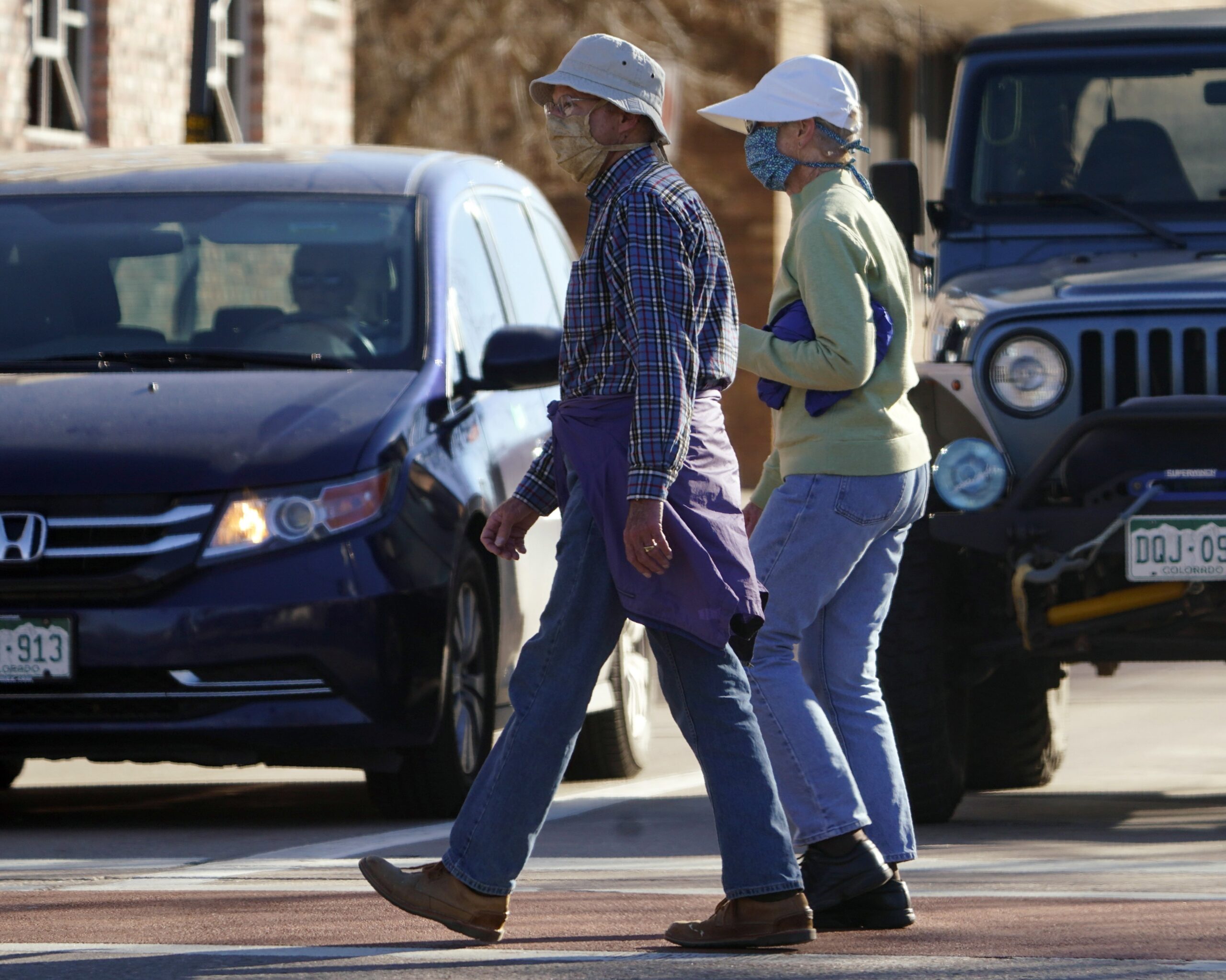 Pedestrians wear face masks