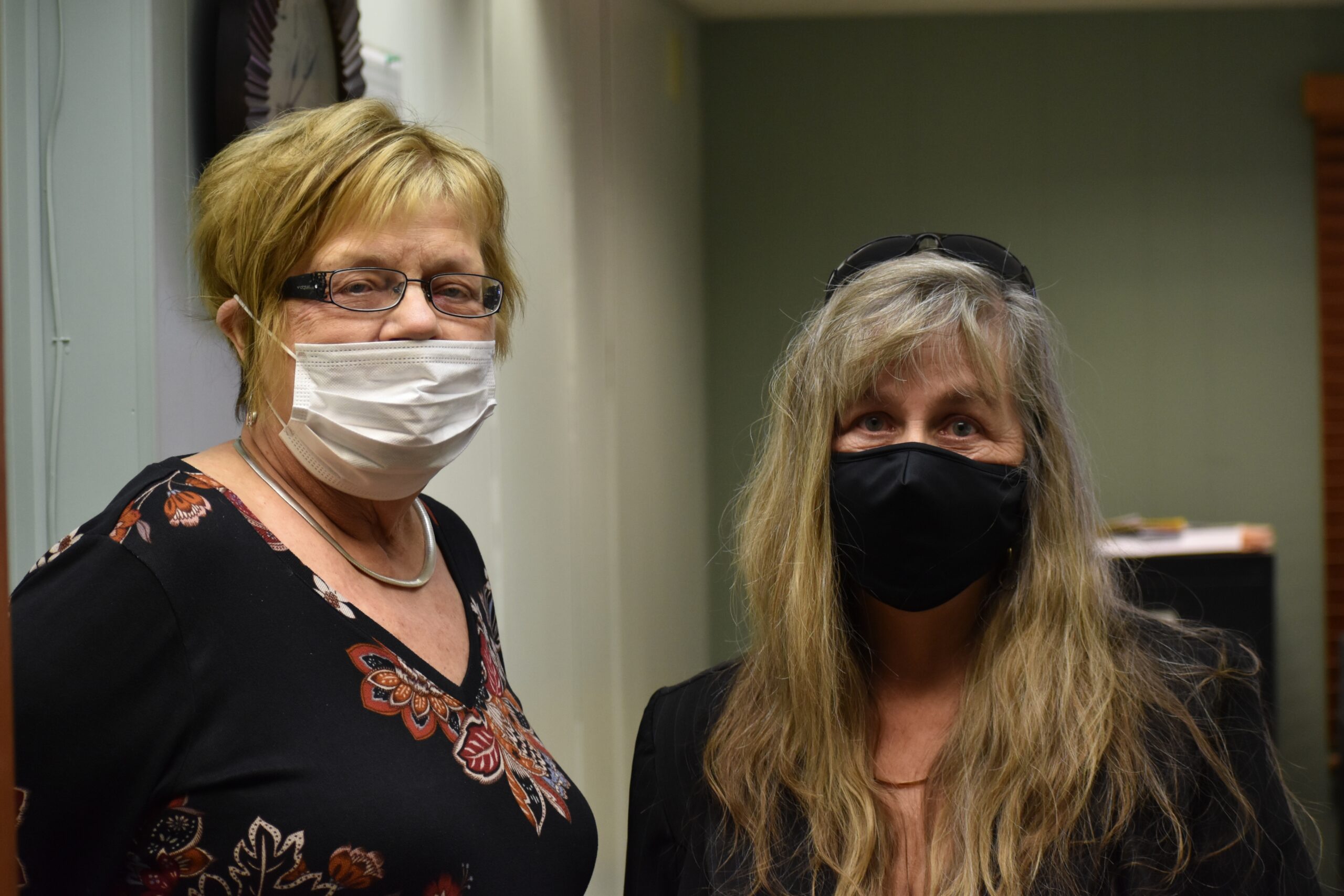 Two voters wearing face masks
