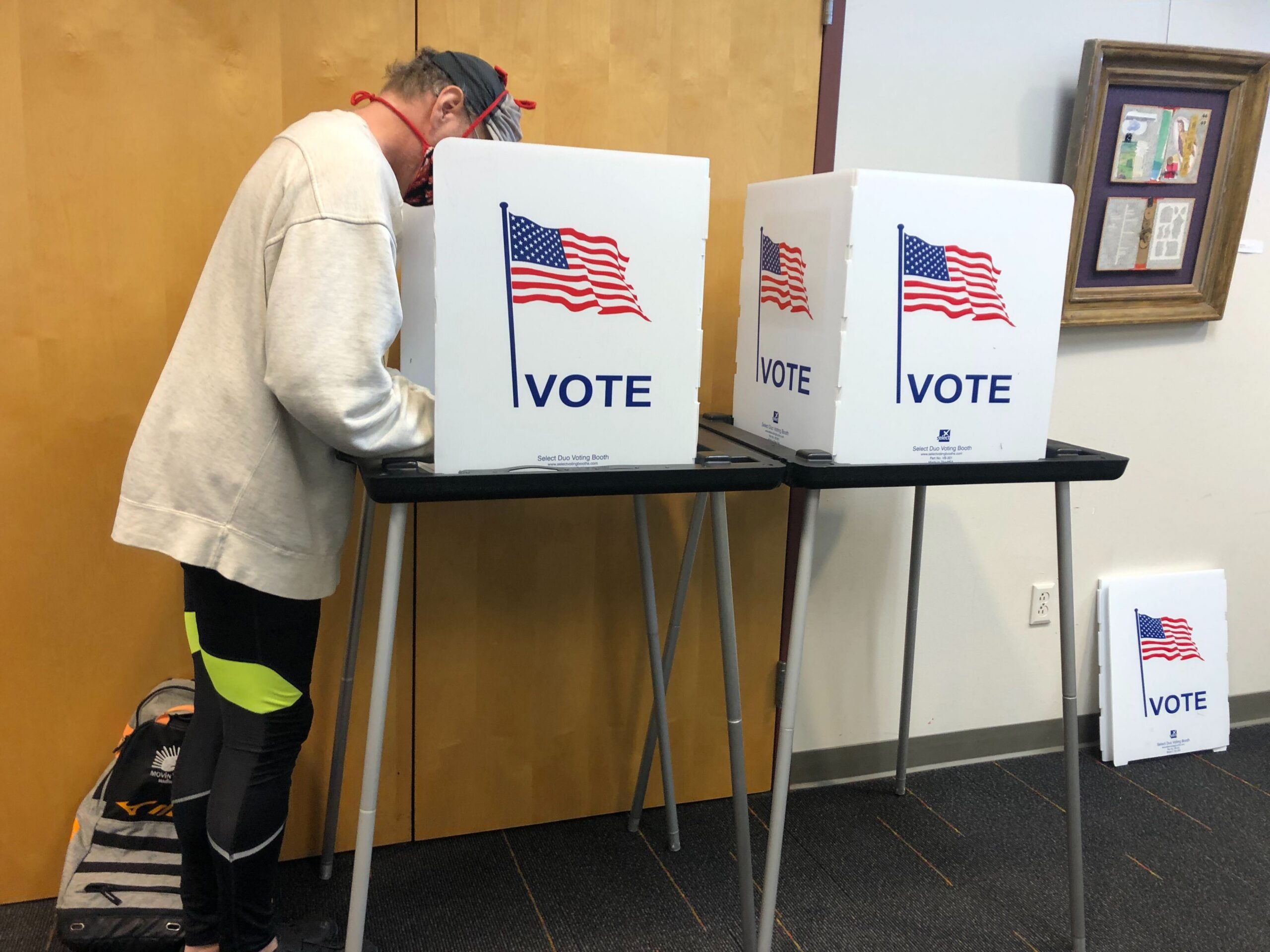 A voter fills out their ballot at Madison Public Library's Hawthorne branch