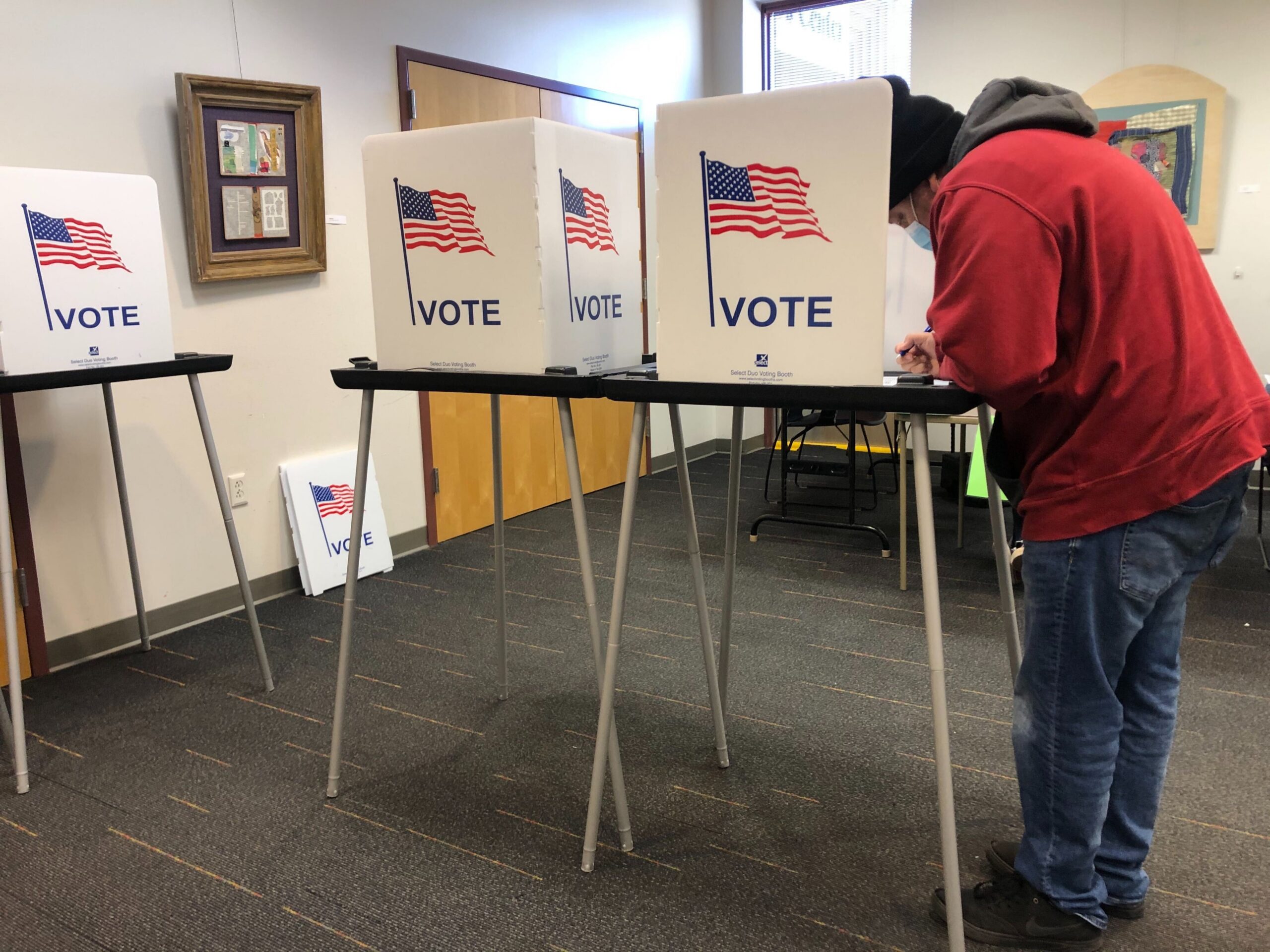 A man votes at Madison Public Library's Hawthorne location