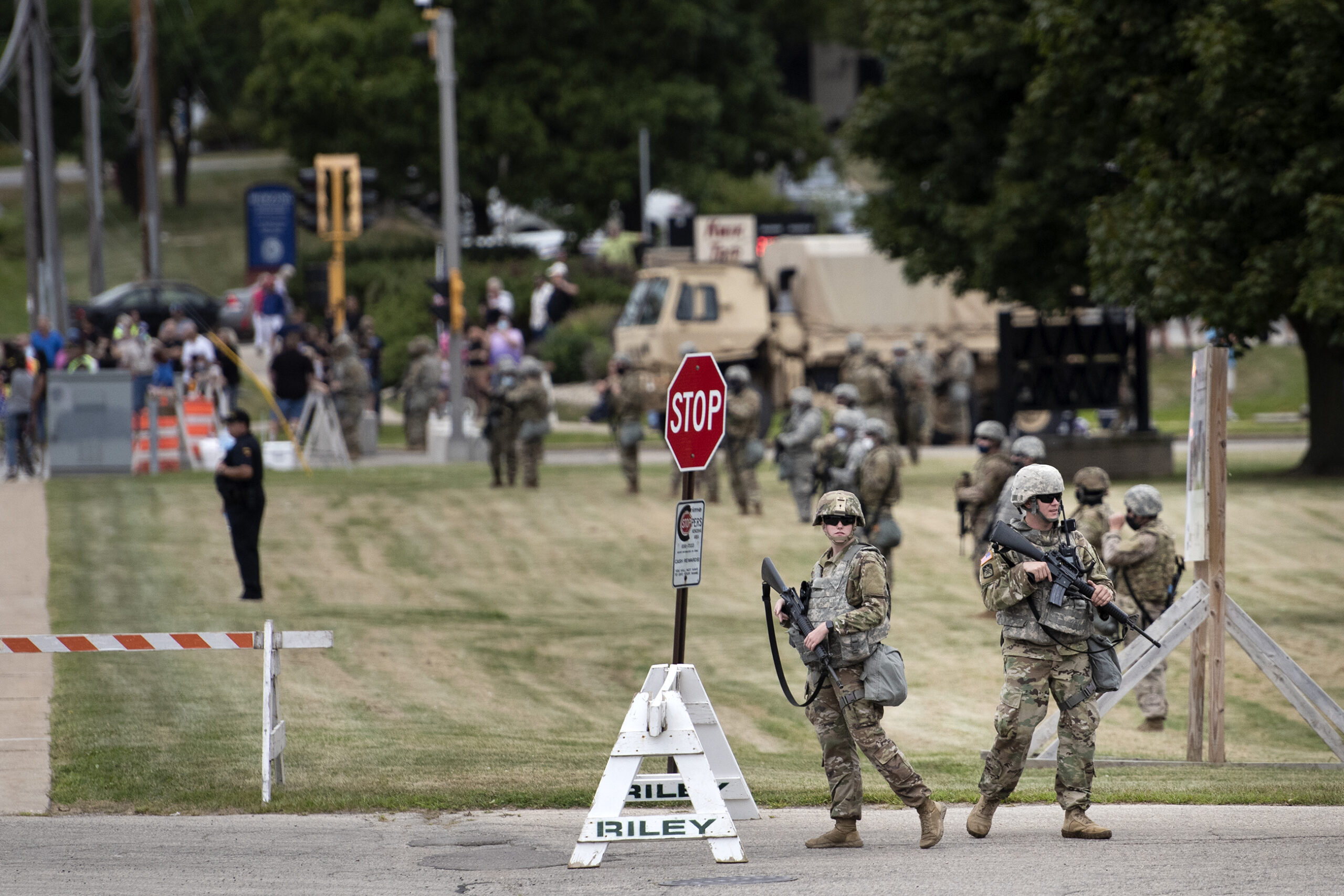 A line of Wisconsin National Guard members form a line outside of a high school