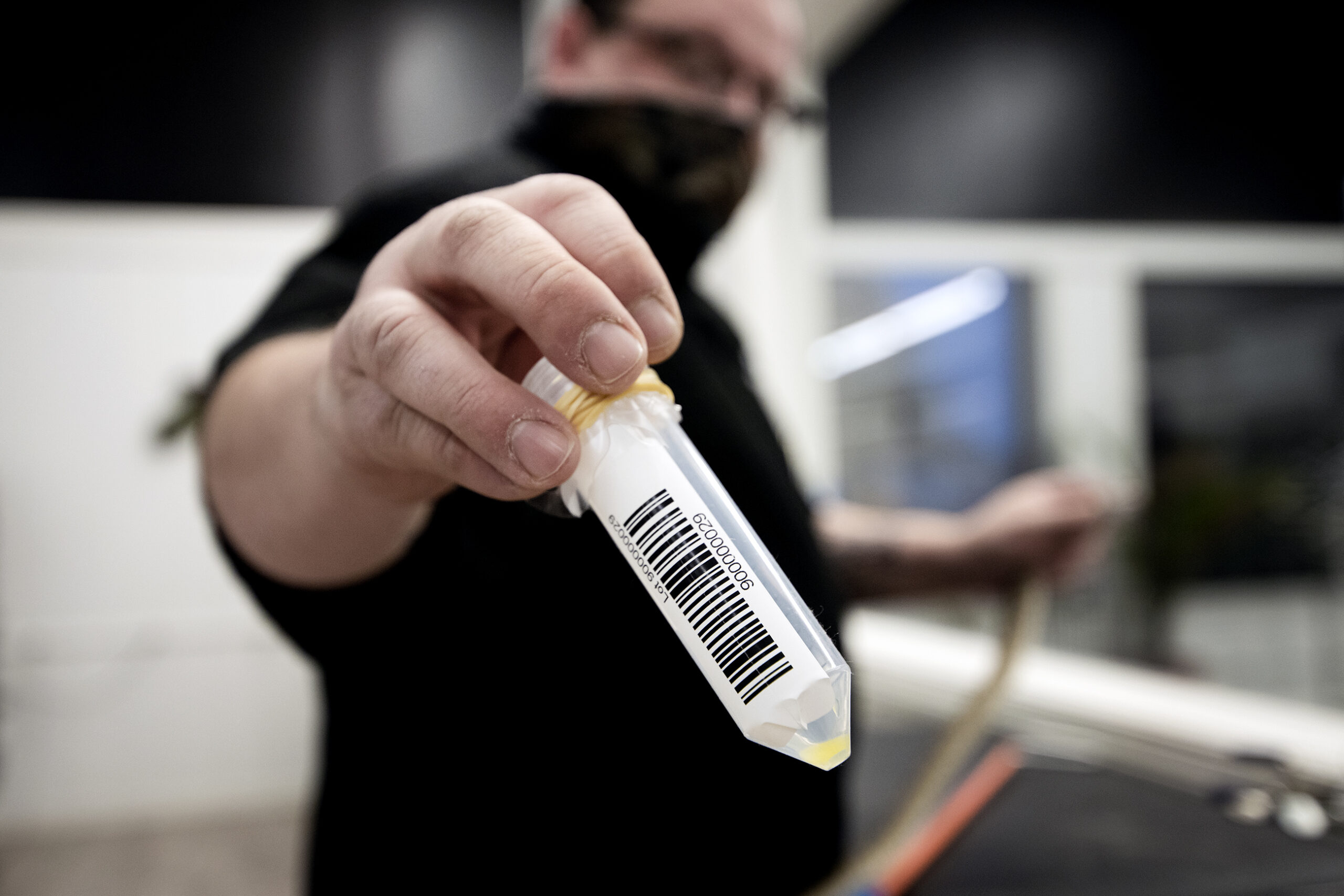 a plastic container with a bar code contains light yellow liquid venom