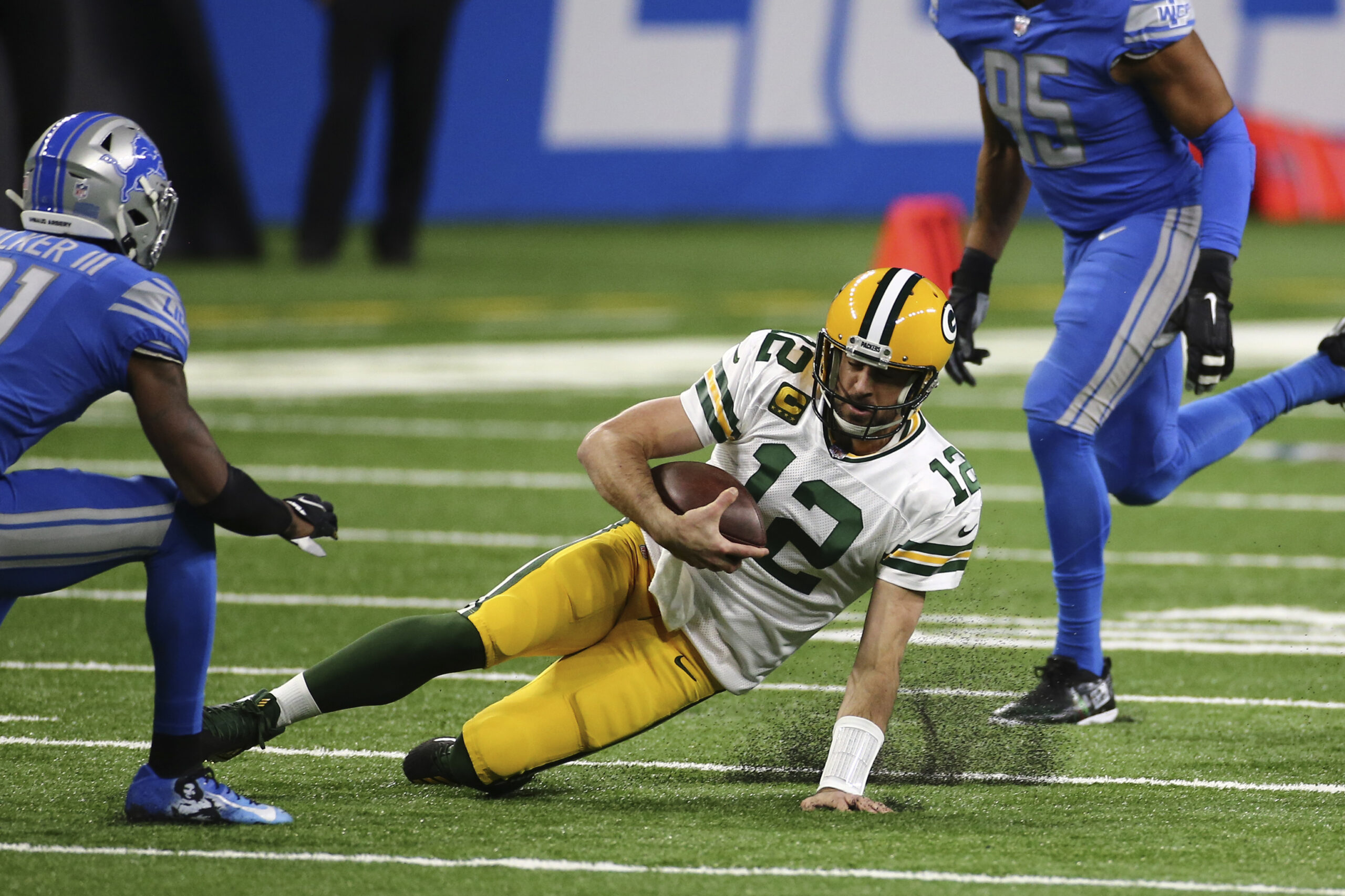Green Bay Packers quarterback Aaron Rodgers slides