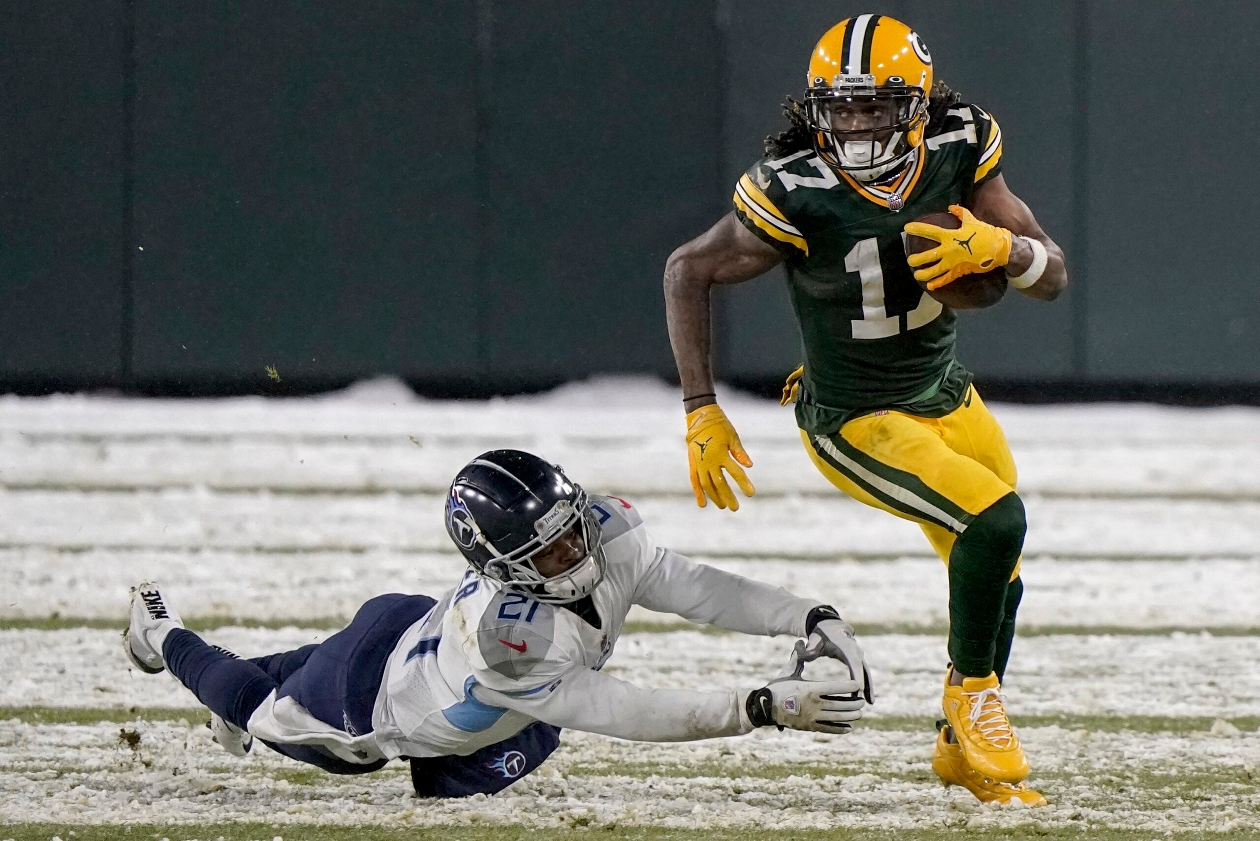 Green Bay Packers' Davante Adams runs past Tennessee Titans' Malcolm Butler