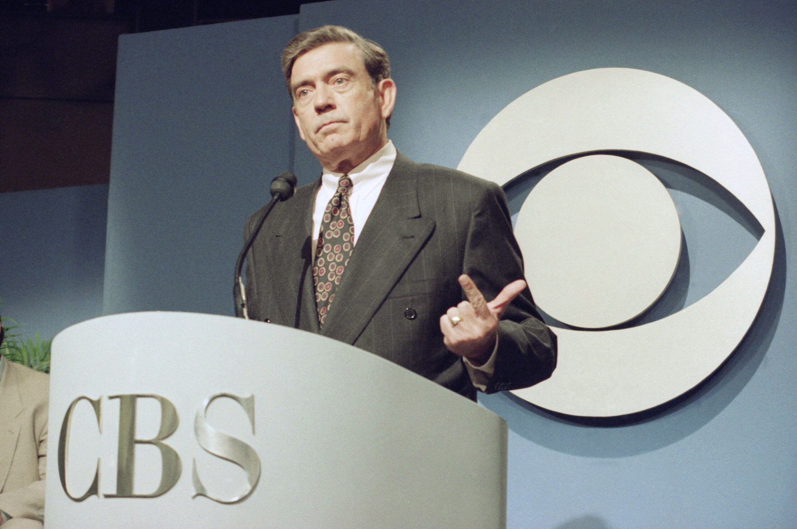 Dan Rather gestures during a news conference in New York