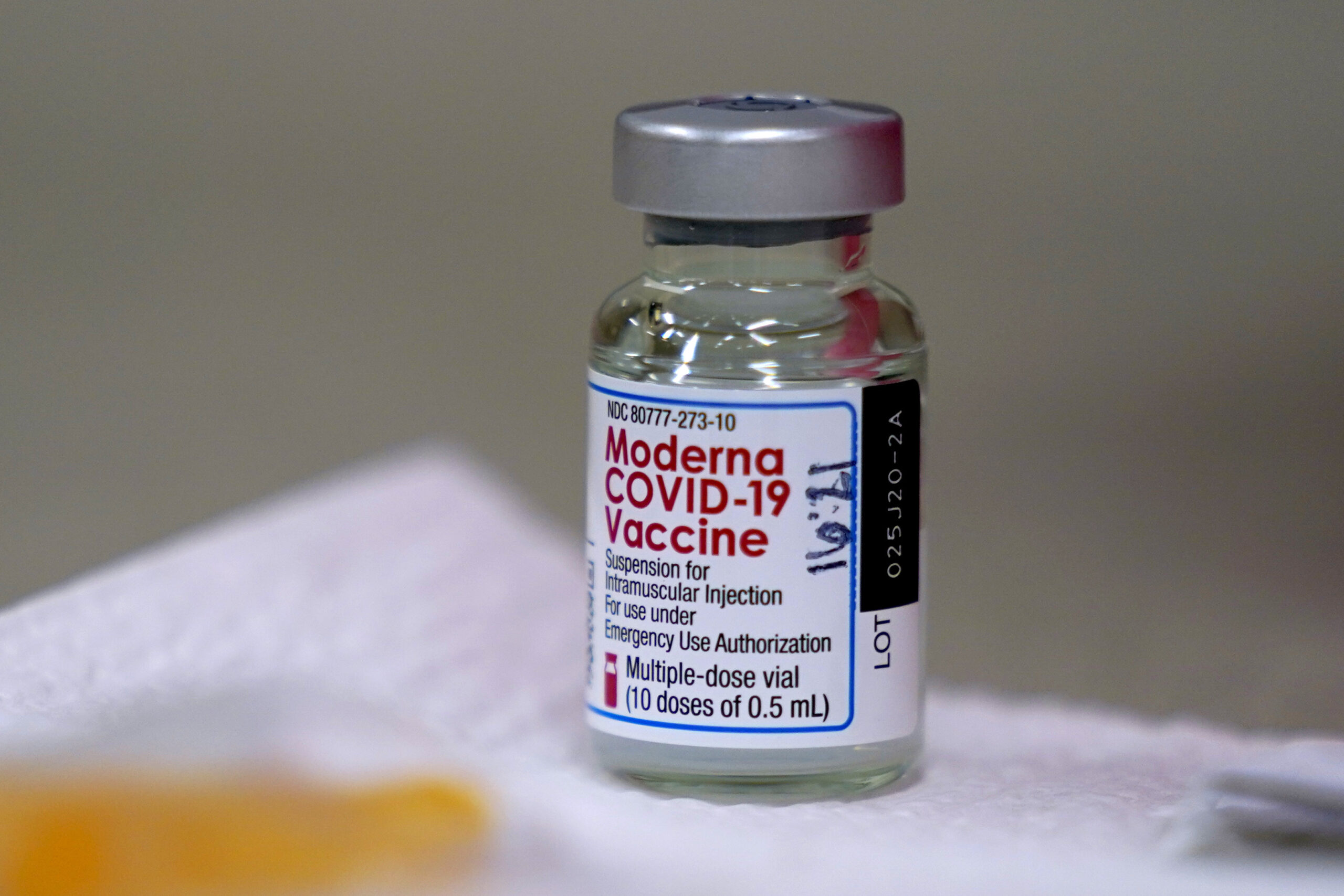 A bottle of Moderna's COVID-19 vaccine is seen on a table