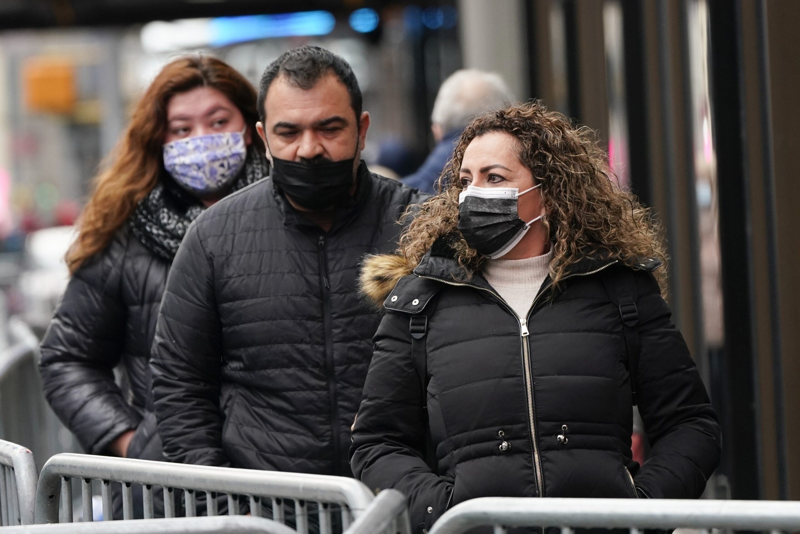 Pedestrians wear protective masks