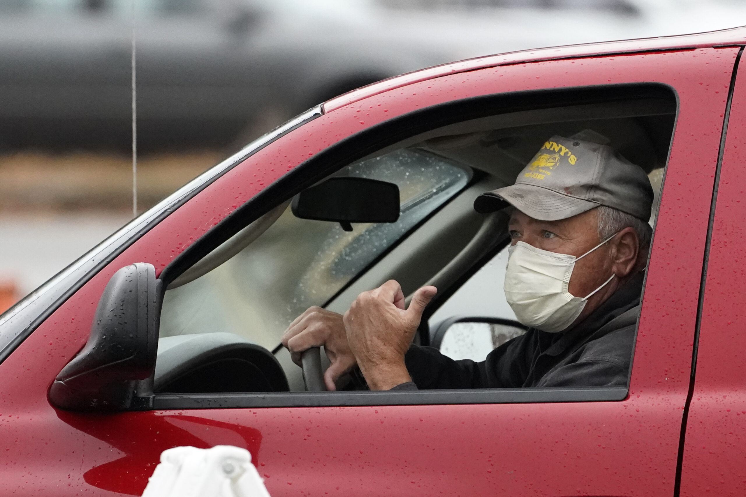 Man in a truck wearing a mask