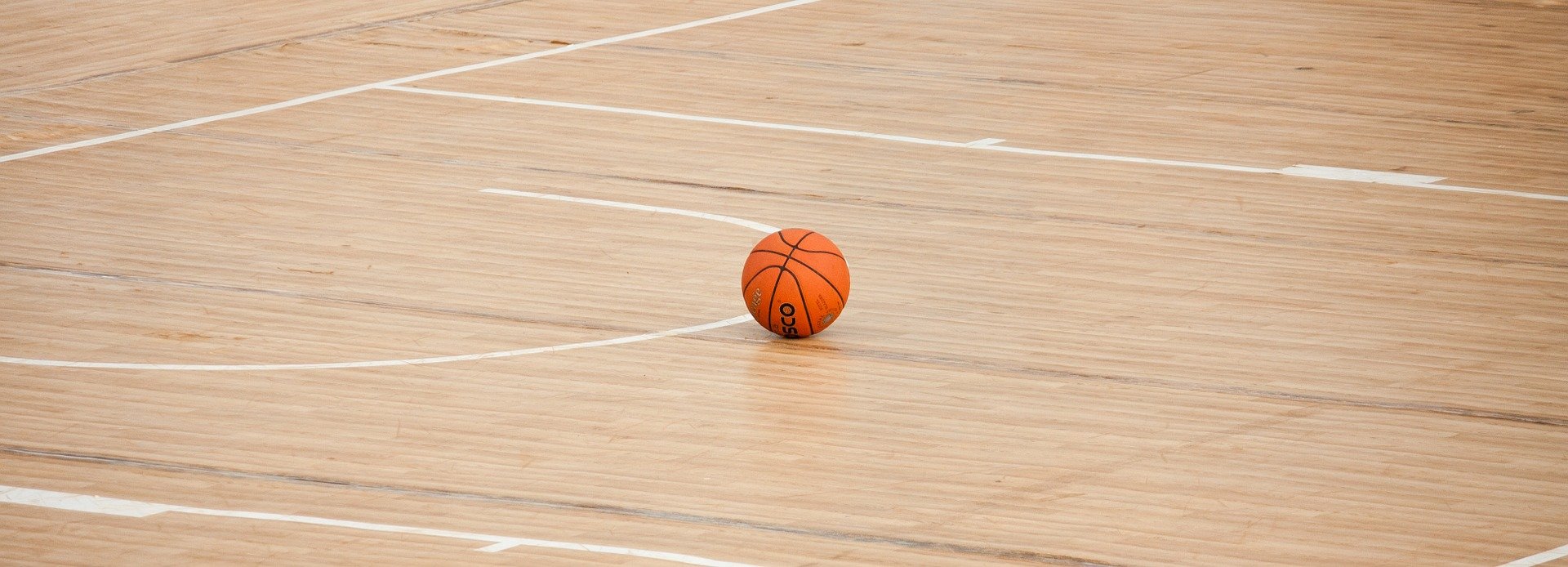 Basketball resting on court.