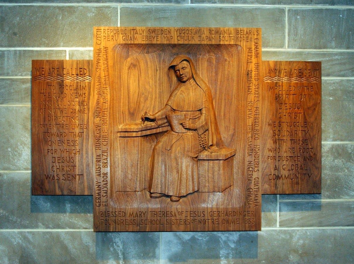 Sister Regine Collins' wood carving of Blessed Theresa Gethardinger, founder of School Sisters of Notre Dame. The carving is at Mary Our Queen Cathedral in Baltimore and includes the countries the SSND can be found in.