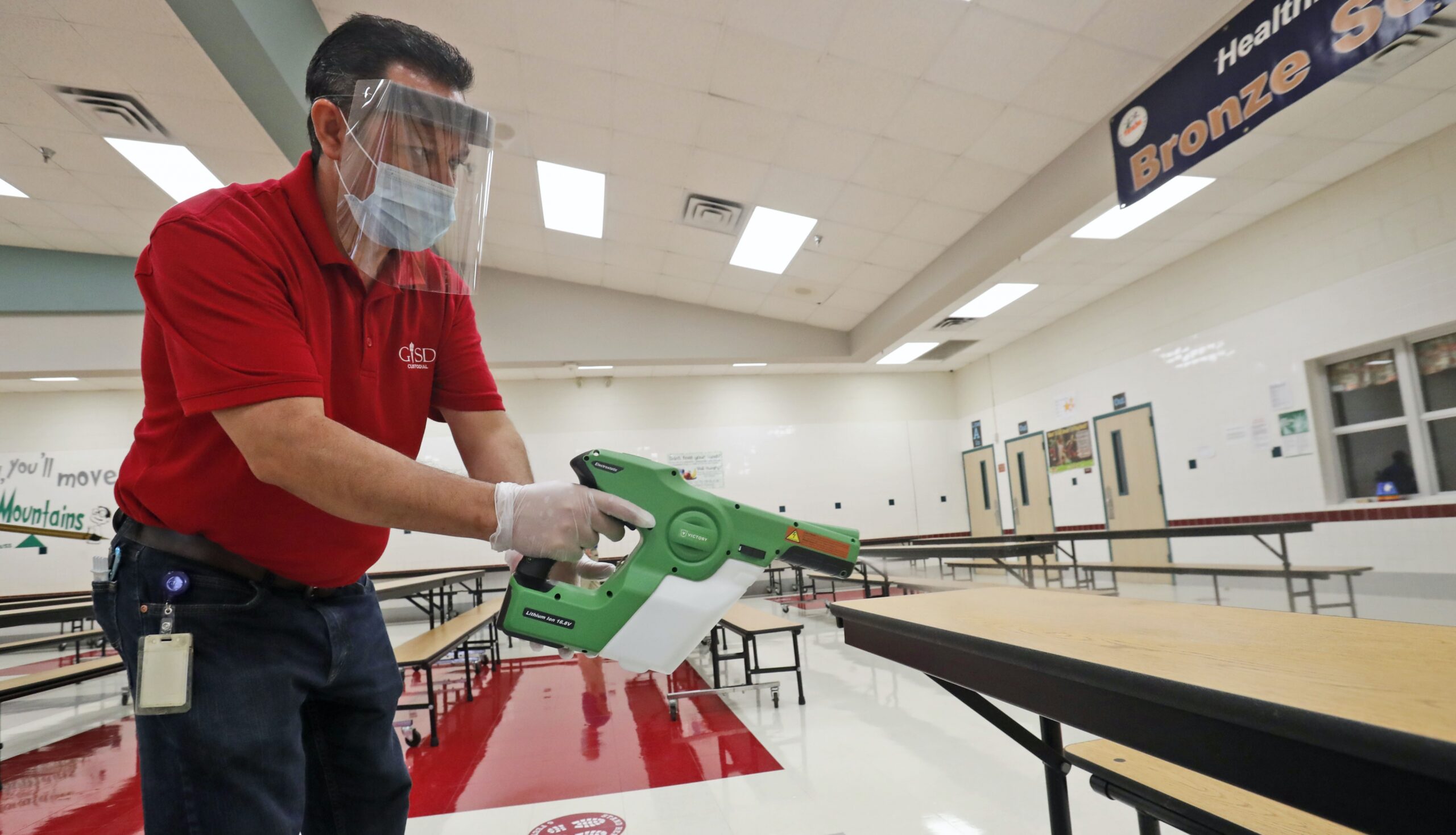 A custodian cleans the cafeteria at a Texas elementary school.