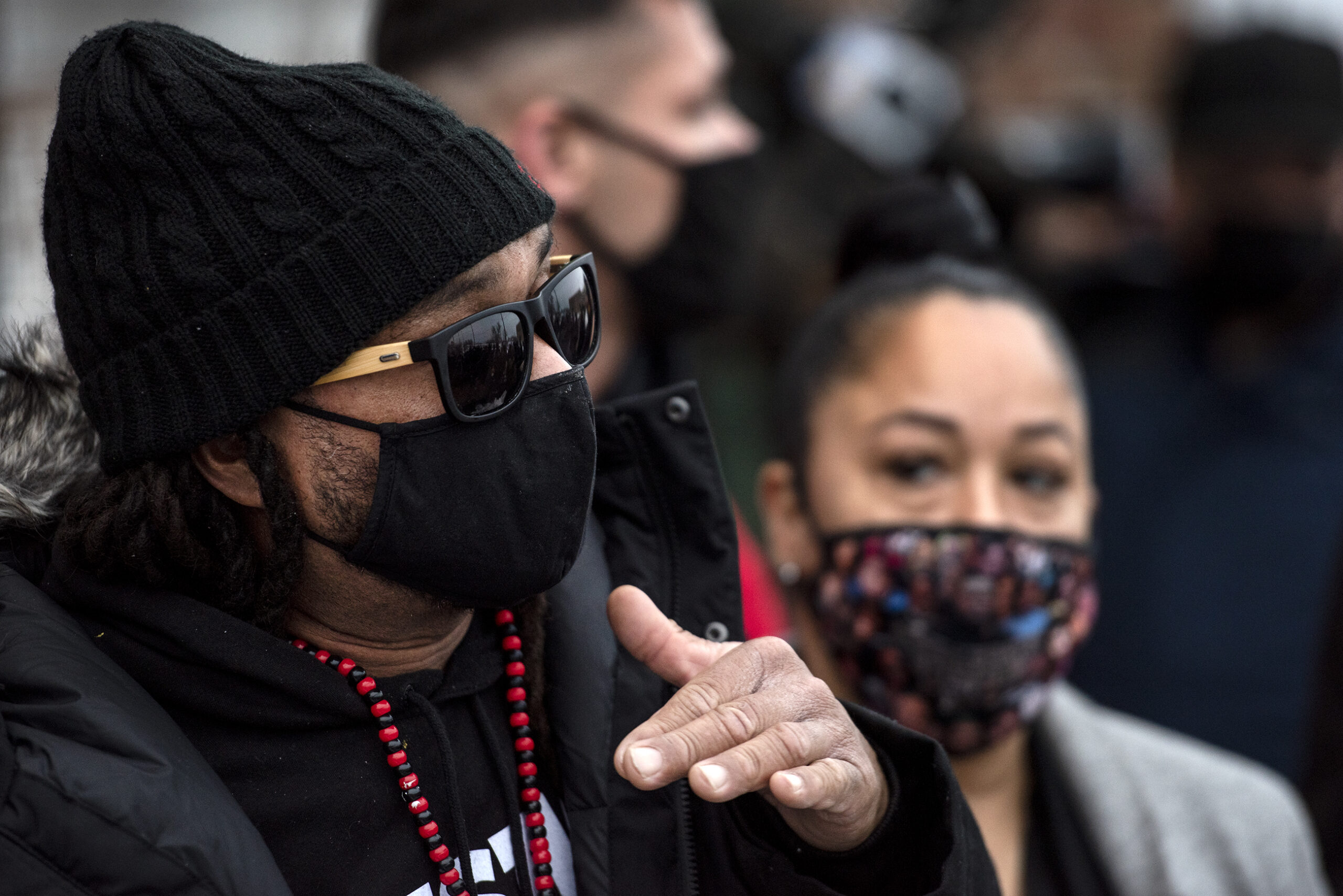 A man gestures as he speaks to reporters