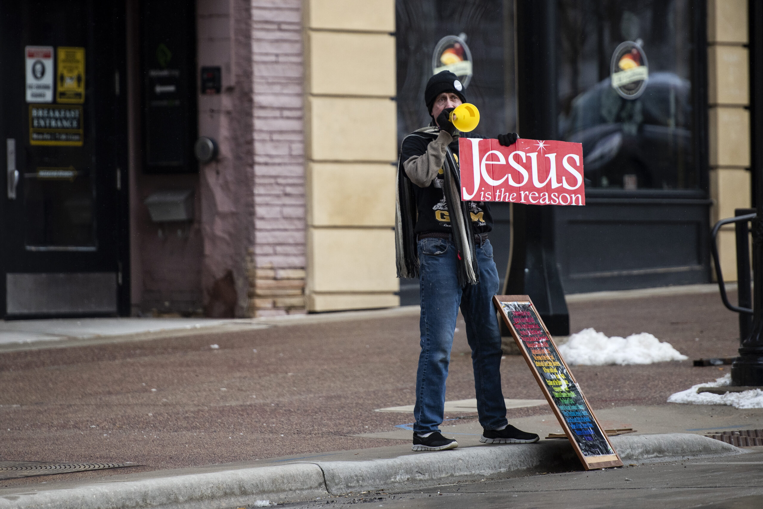 A man holds a sign that says 