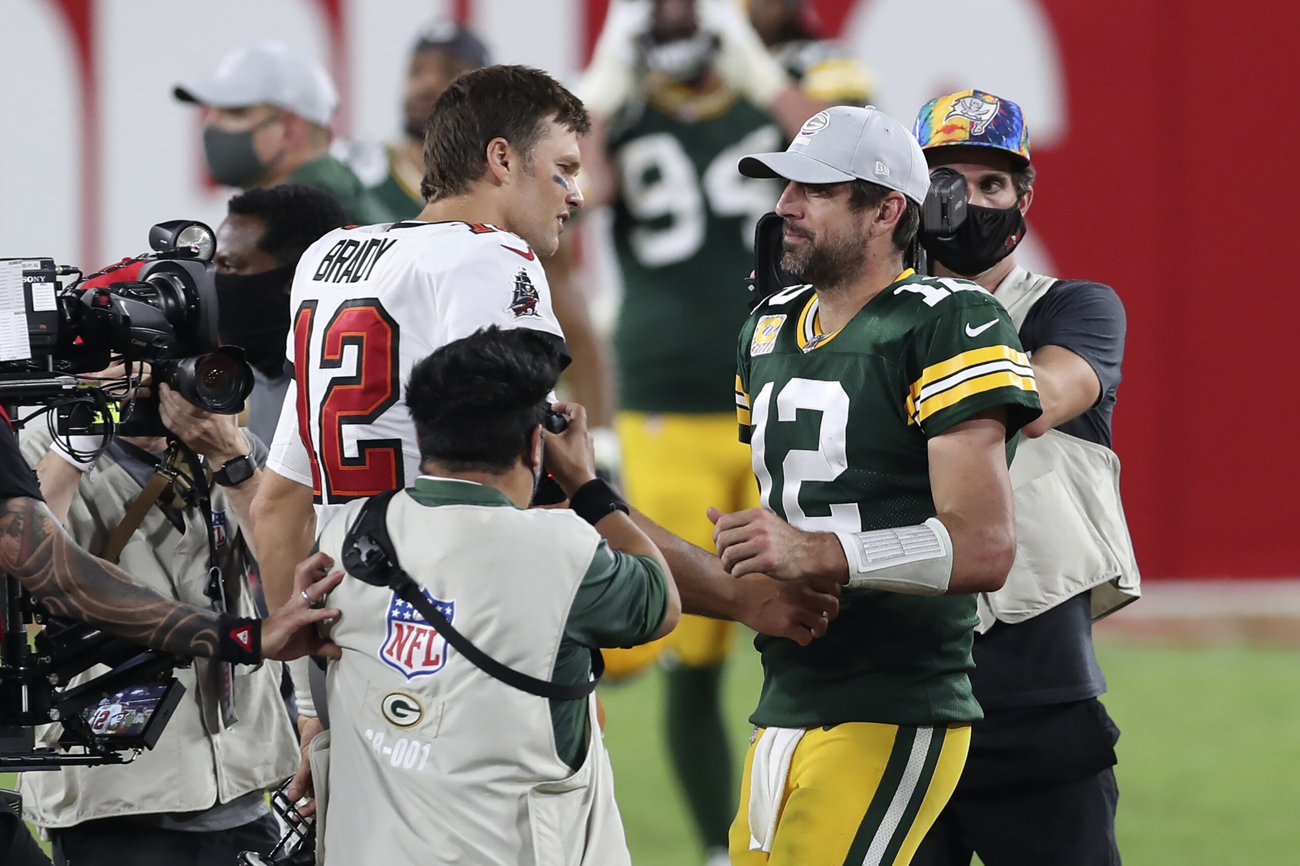 Tom Brady and Aaron Rodgers shake hands after a game