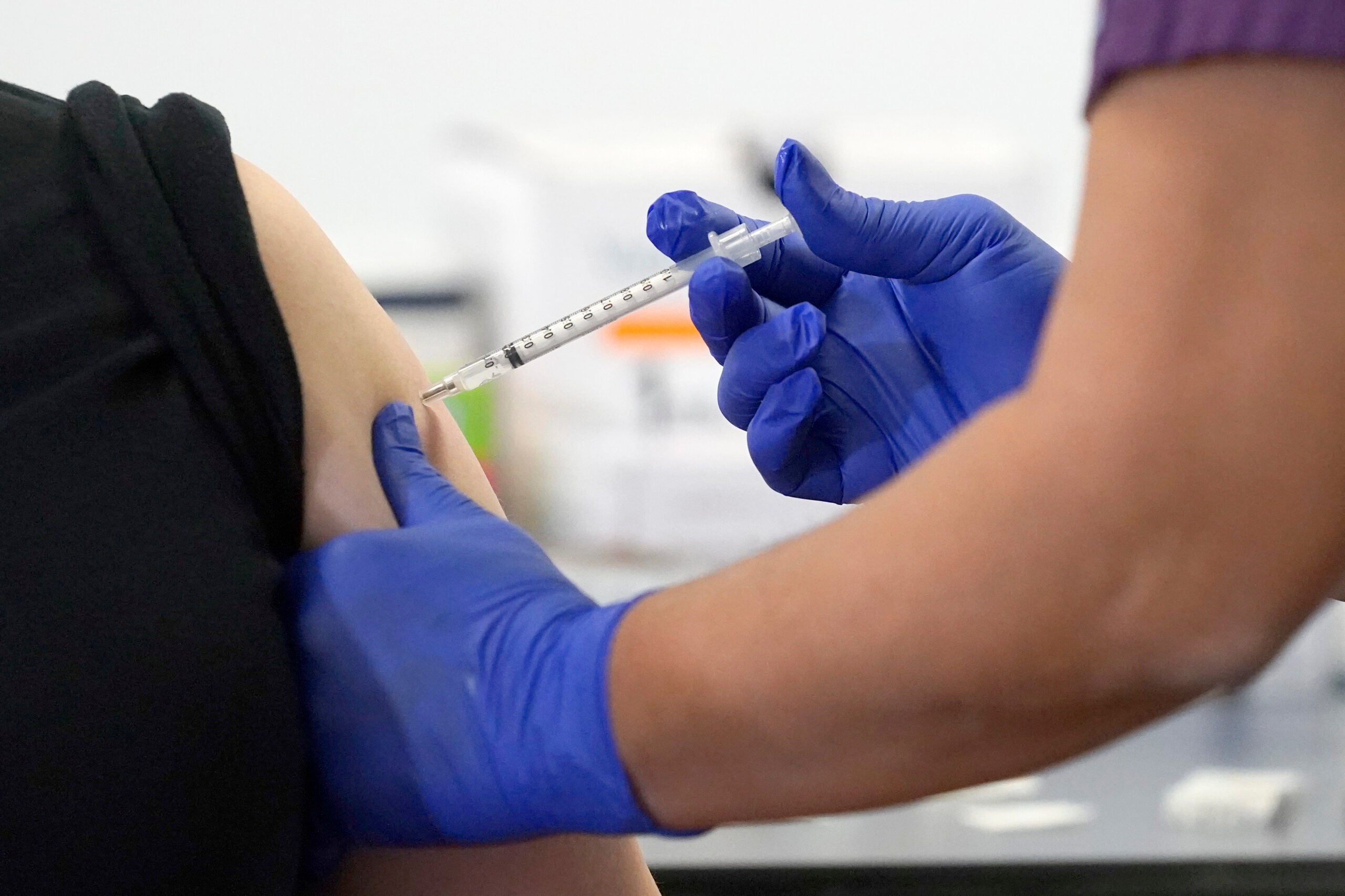 A nurse administers a coronavirus vaccine