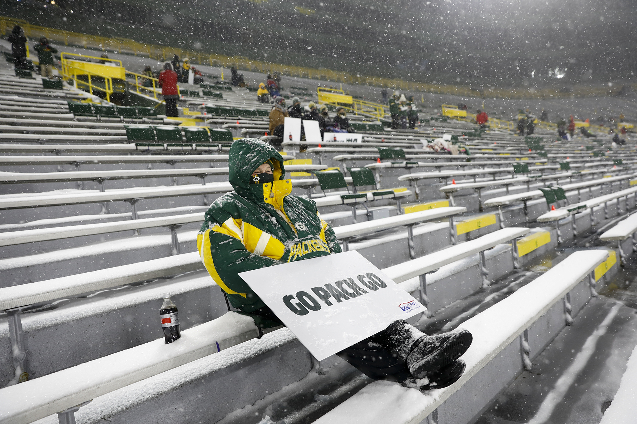 A few fans watch in Lambeau Field during the first half of an NFL football game