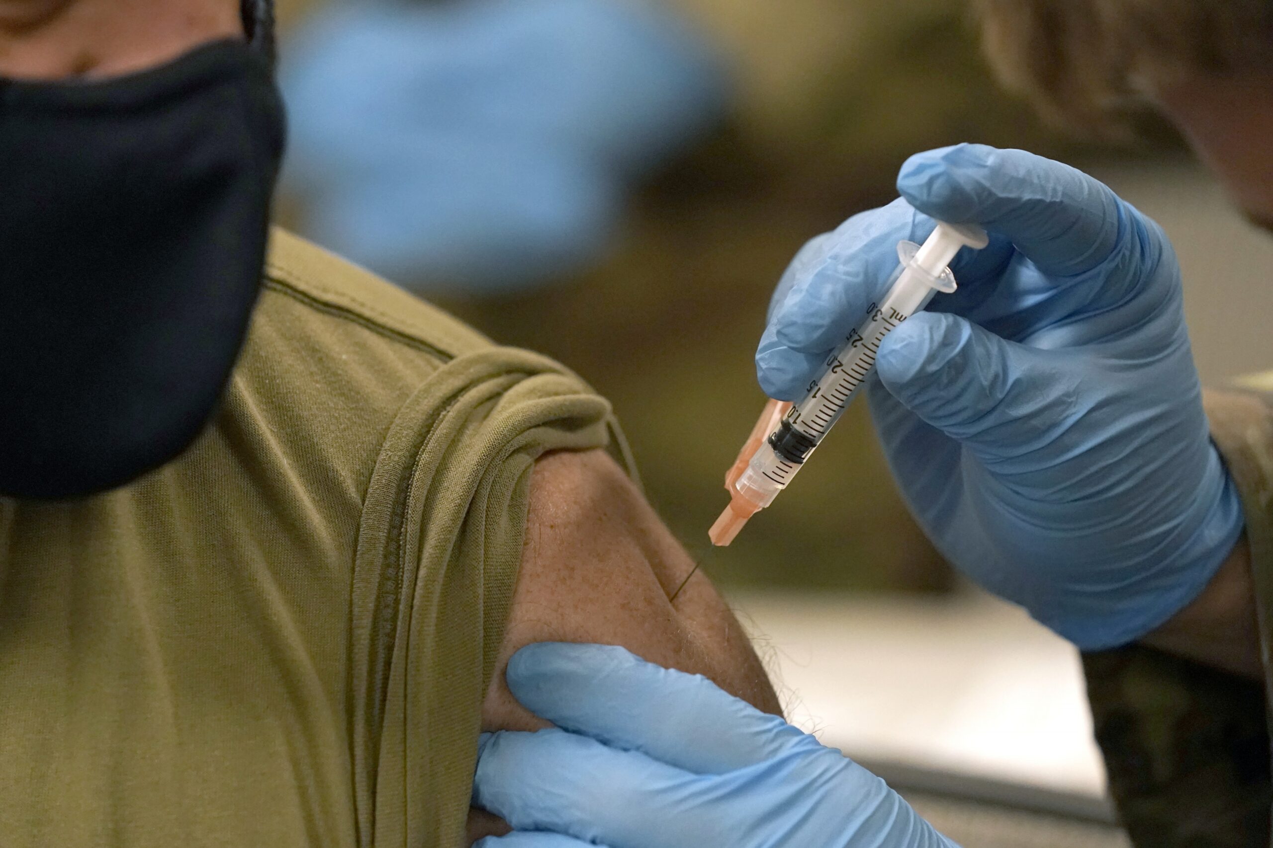 A member of the Mississippi National Guard receives a dose of the Moderna COVID-19 vaccine