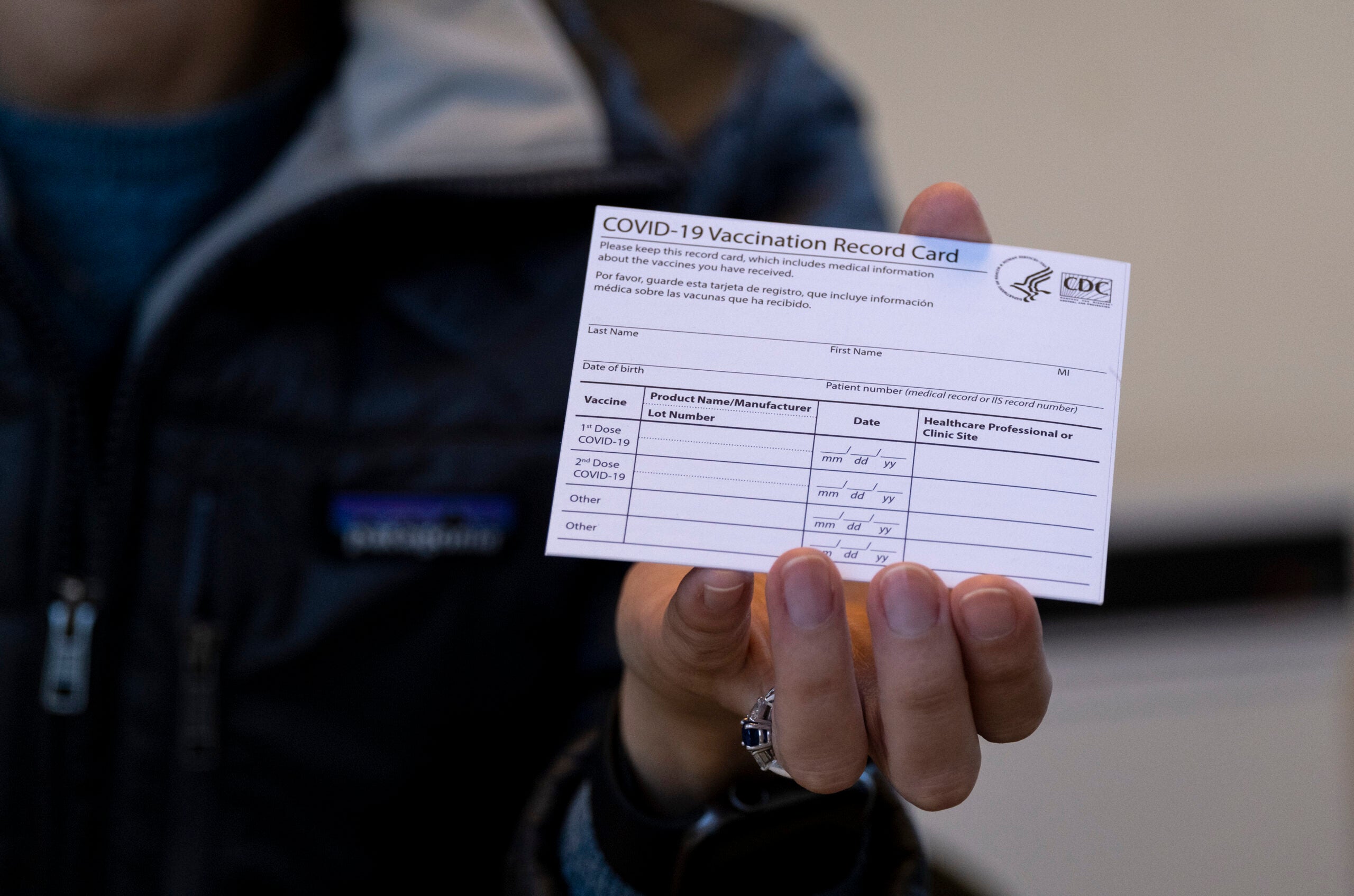 Sarah Gonzalez, a Nurse Practitioner, displays a COVID-19 vaccine card