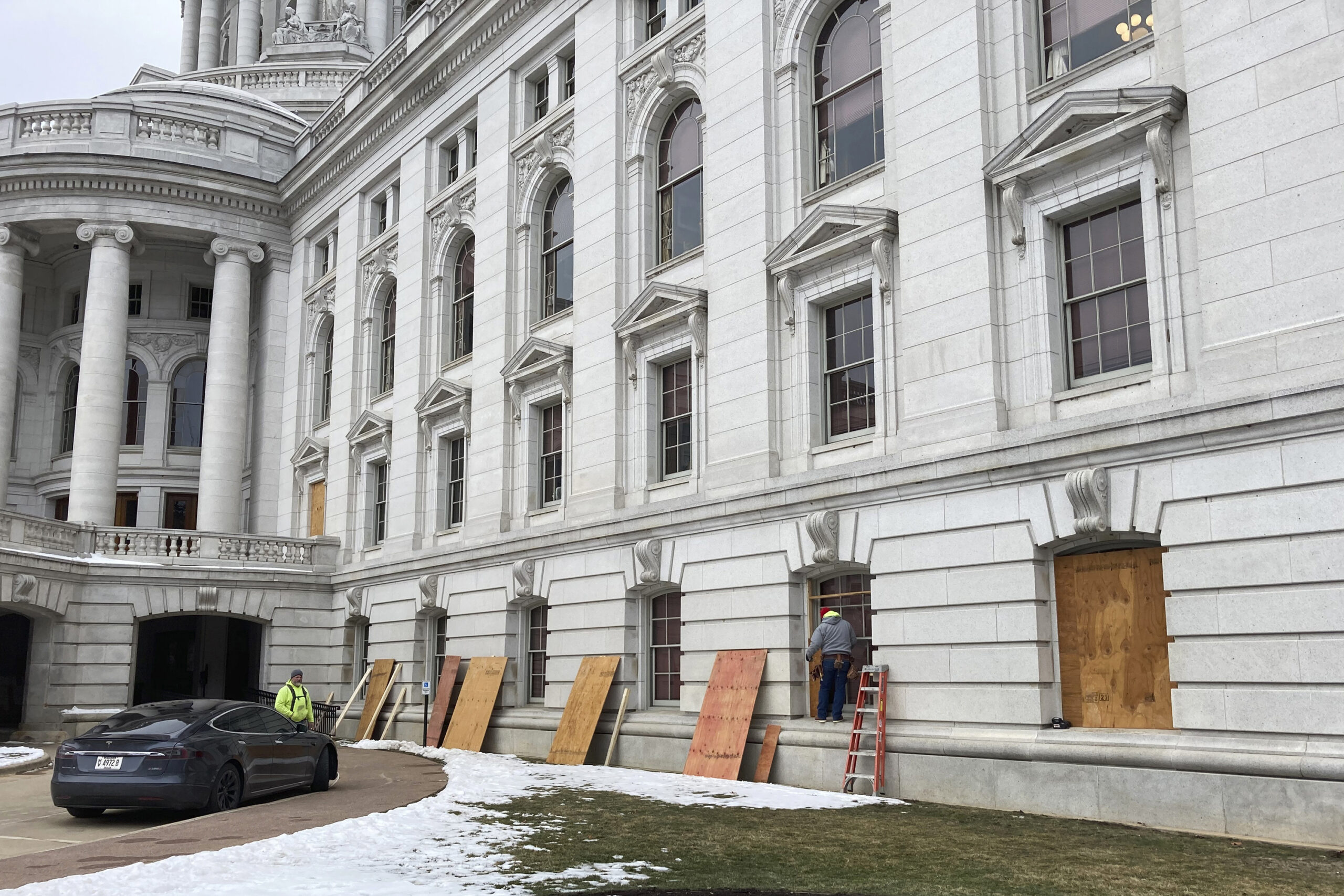 Workers begin boarding up the Wisconsin state Capitol