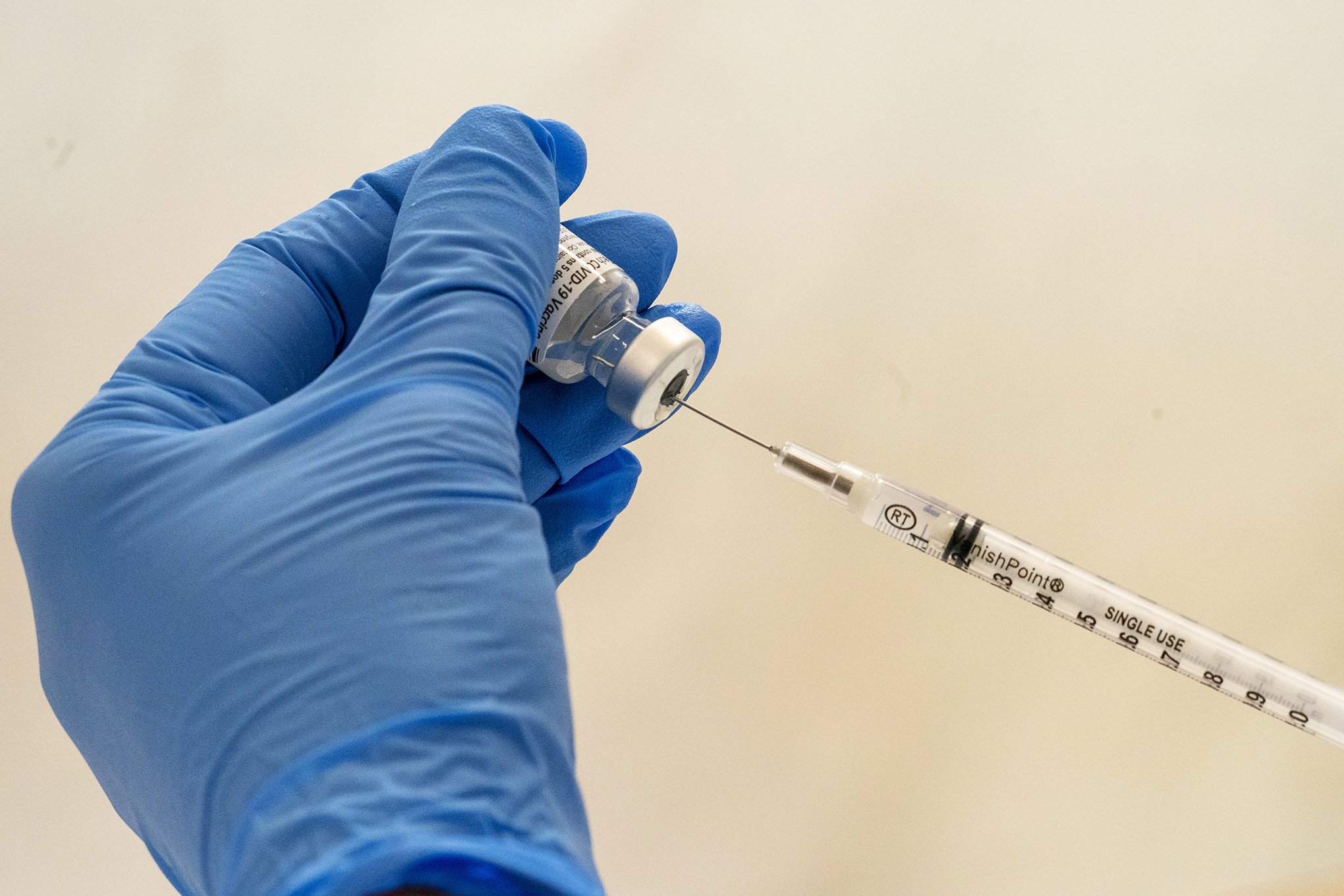Pharmacist Paula Agoglia fills a syringe with the COVID-19 vaccine