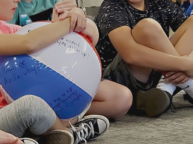 Students in the OSC Charter School at Lodi Elementary pass around an inflated ball as they share their names and an interesting fact about themselves during a lesson with school psychologist Andi Rubino