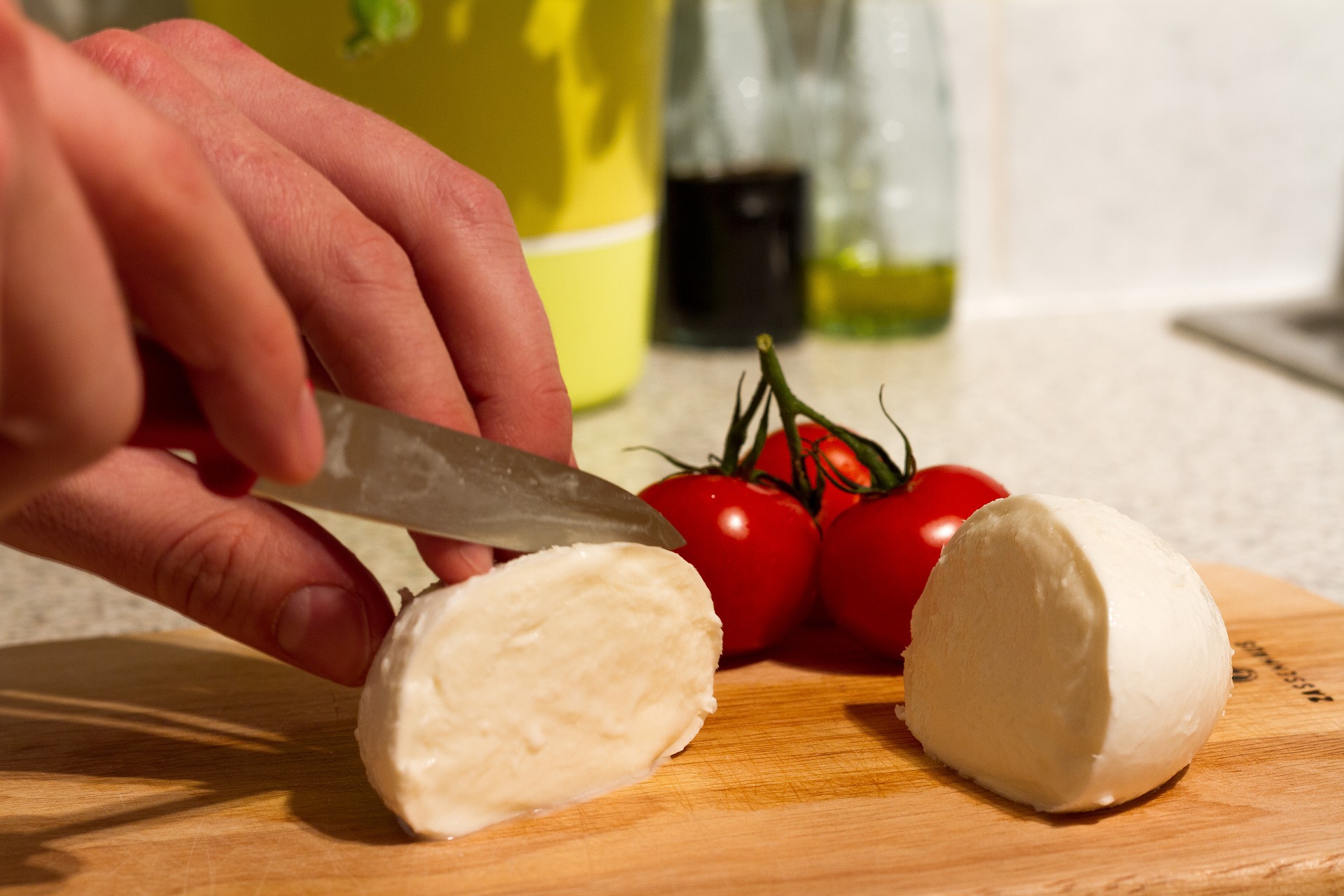 Cutting fresh mozzarella cheese.