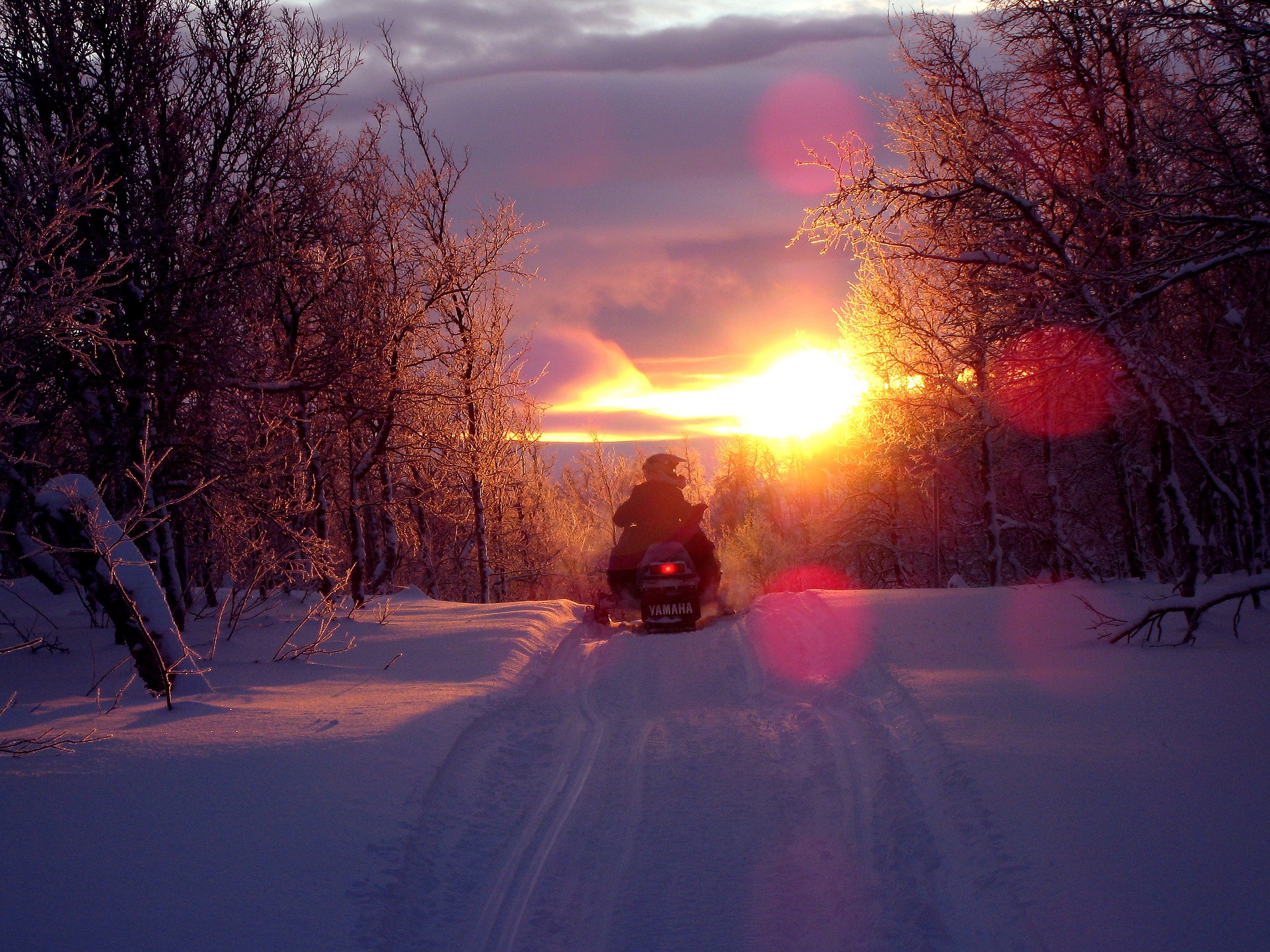 Snowmobile against the sunset.