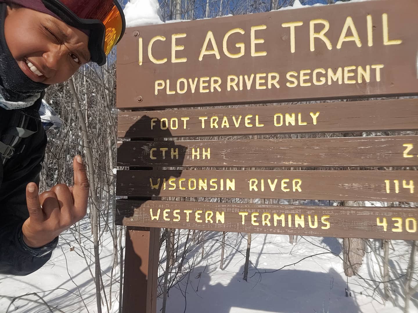 Emily Ford next to an Ice Age Trail sign