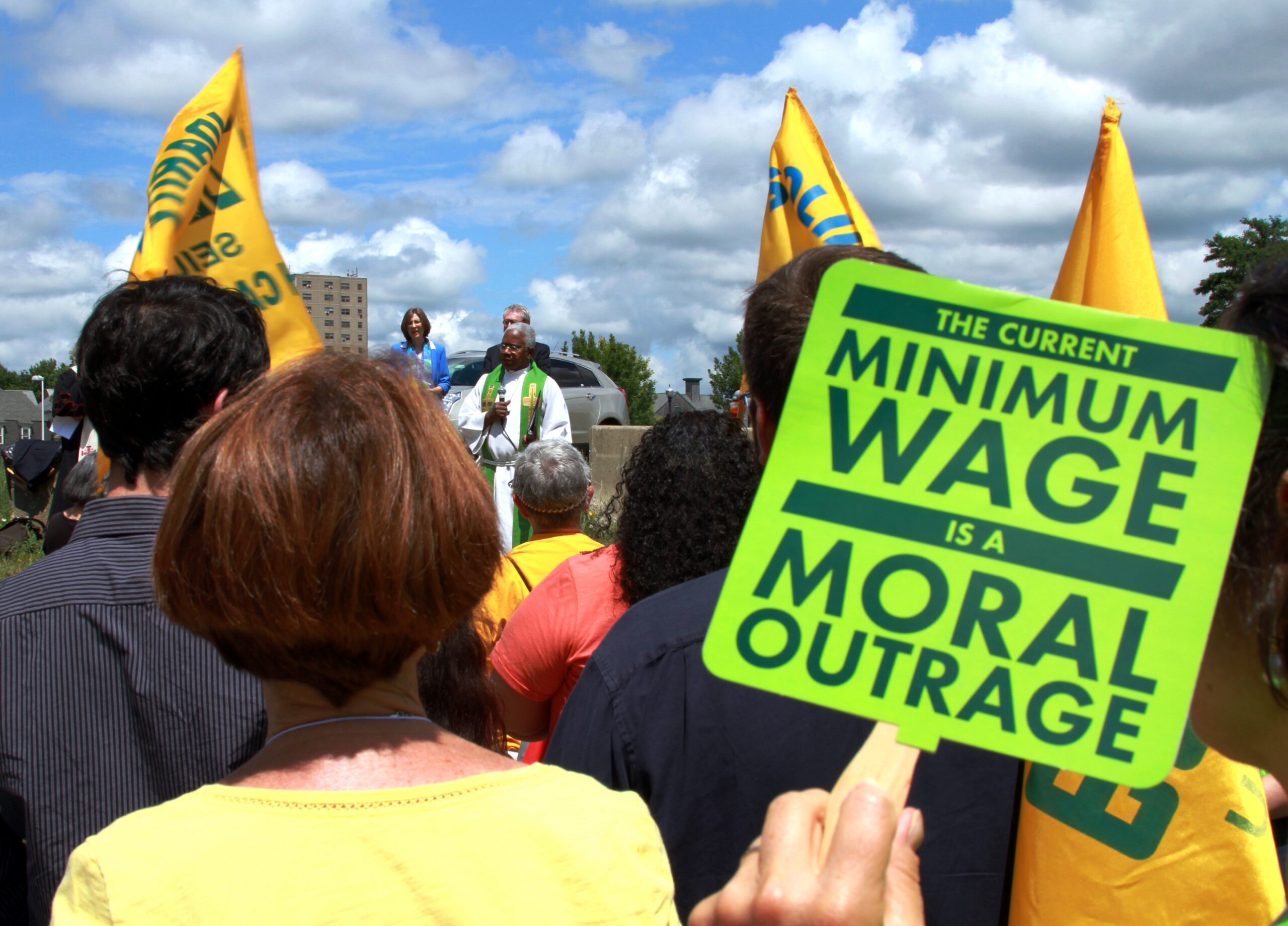 Worker holds up sign during minimum wage strike
