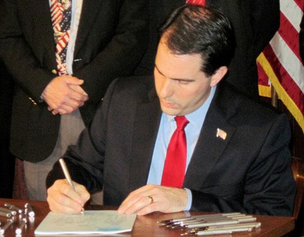 Gov. Walker signs Act 10 into law