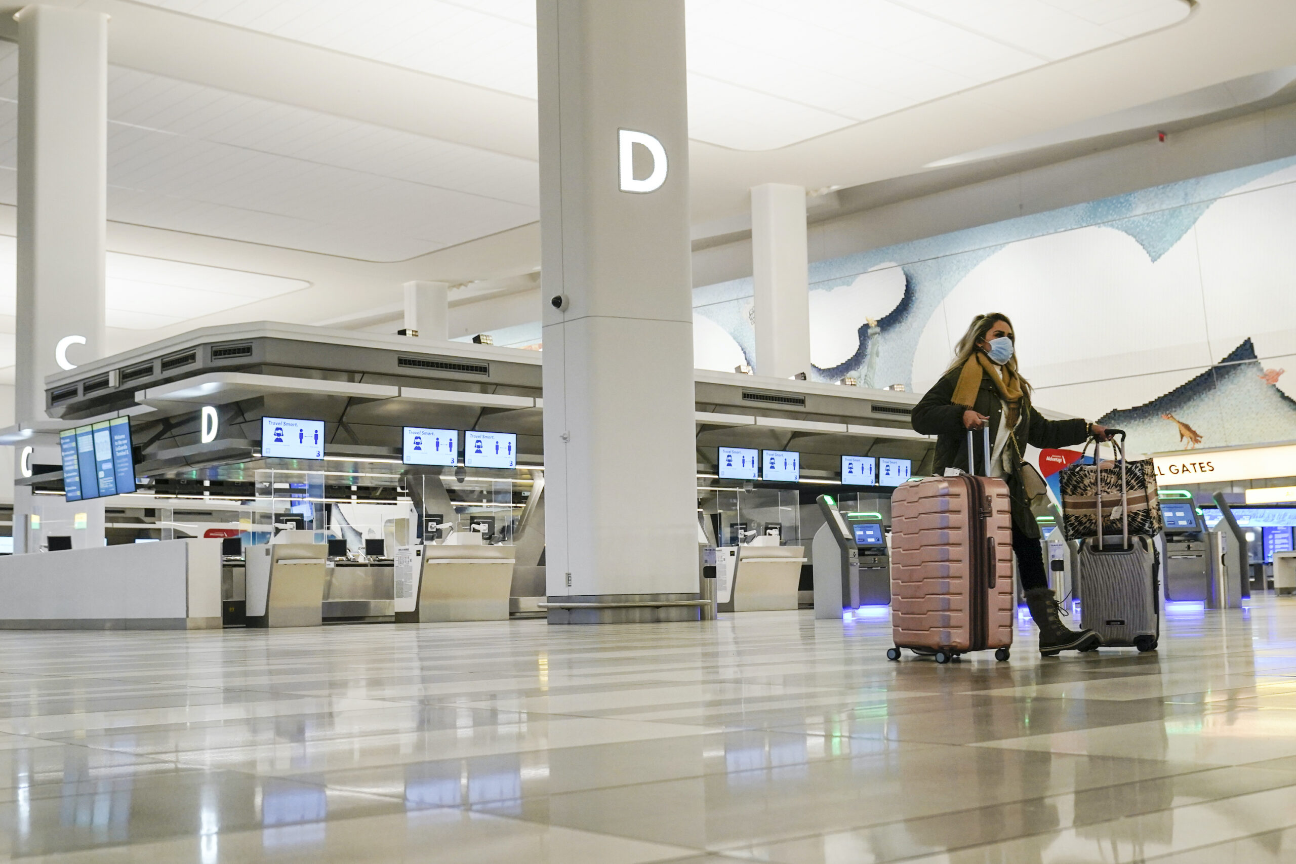 A traveler walks through Terminal B of LaGuardia Airport in New York.