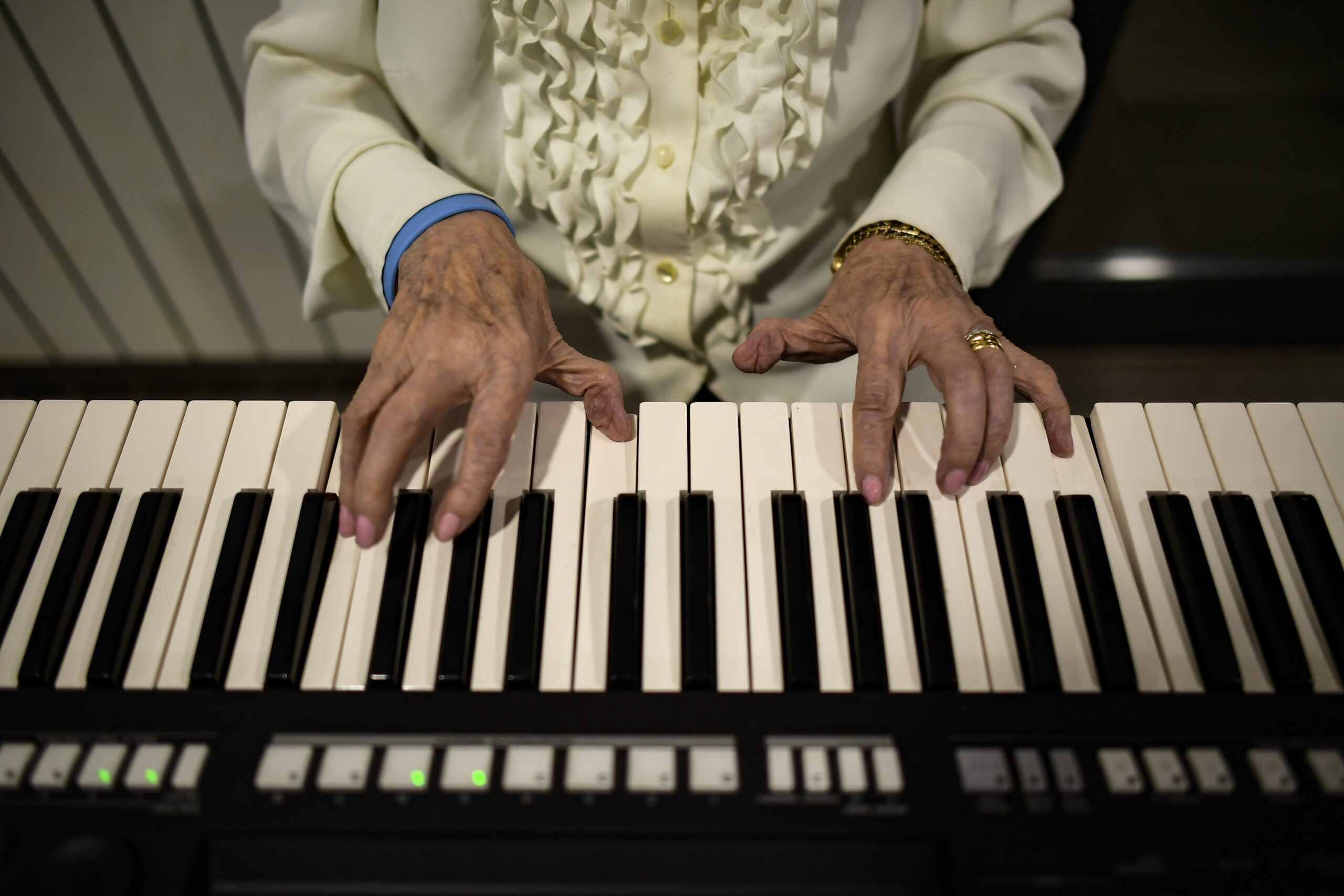 Conchita, 90 years old, a resident of the San Jeronimo nursing home, plays a piano during New Year's Eve celebrations