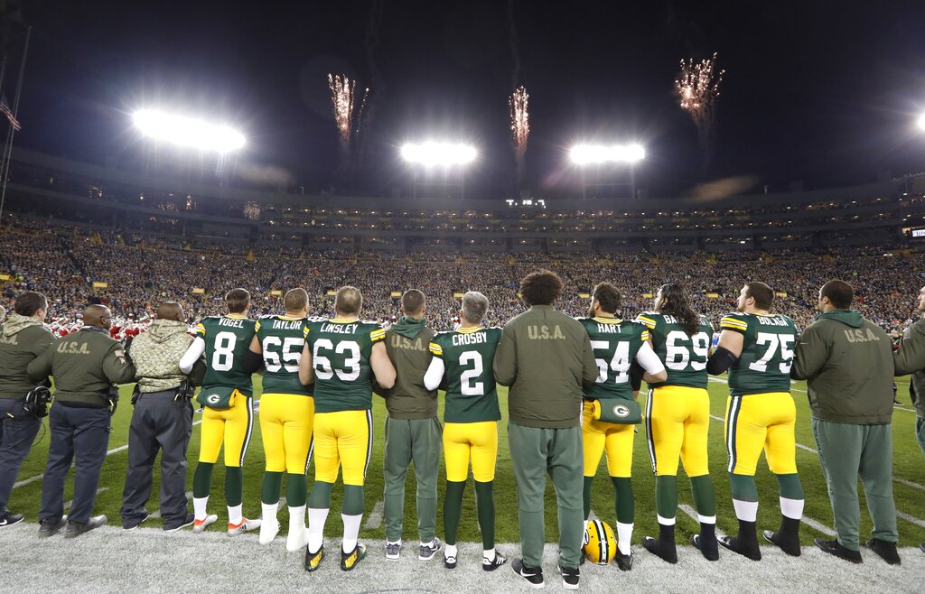 Players line up for the national anthem before a Green Bay Packers game at Lambeau Field