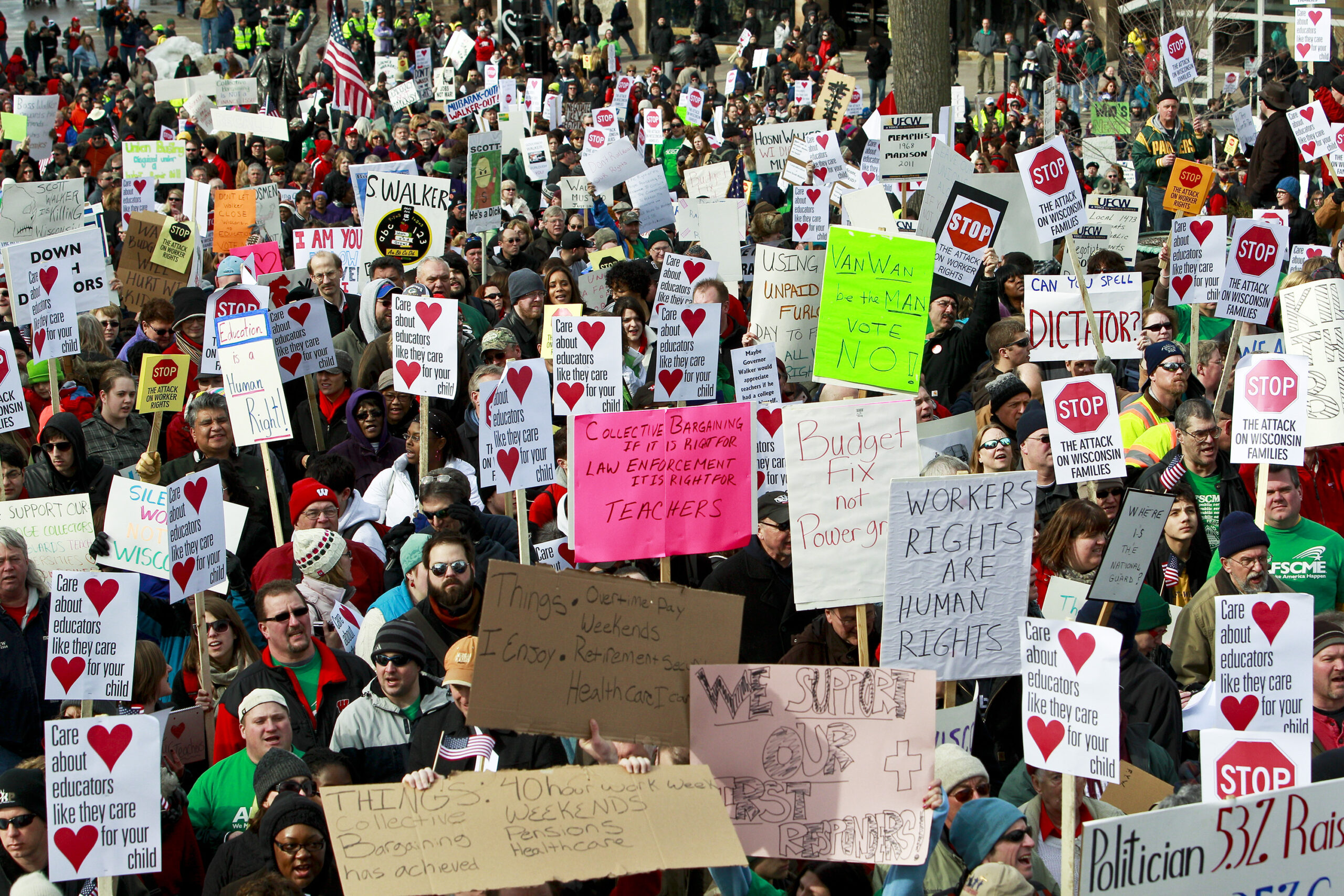 Protesters hold signs