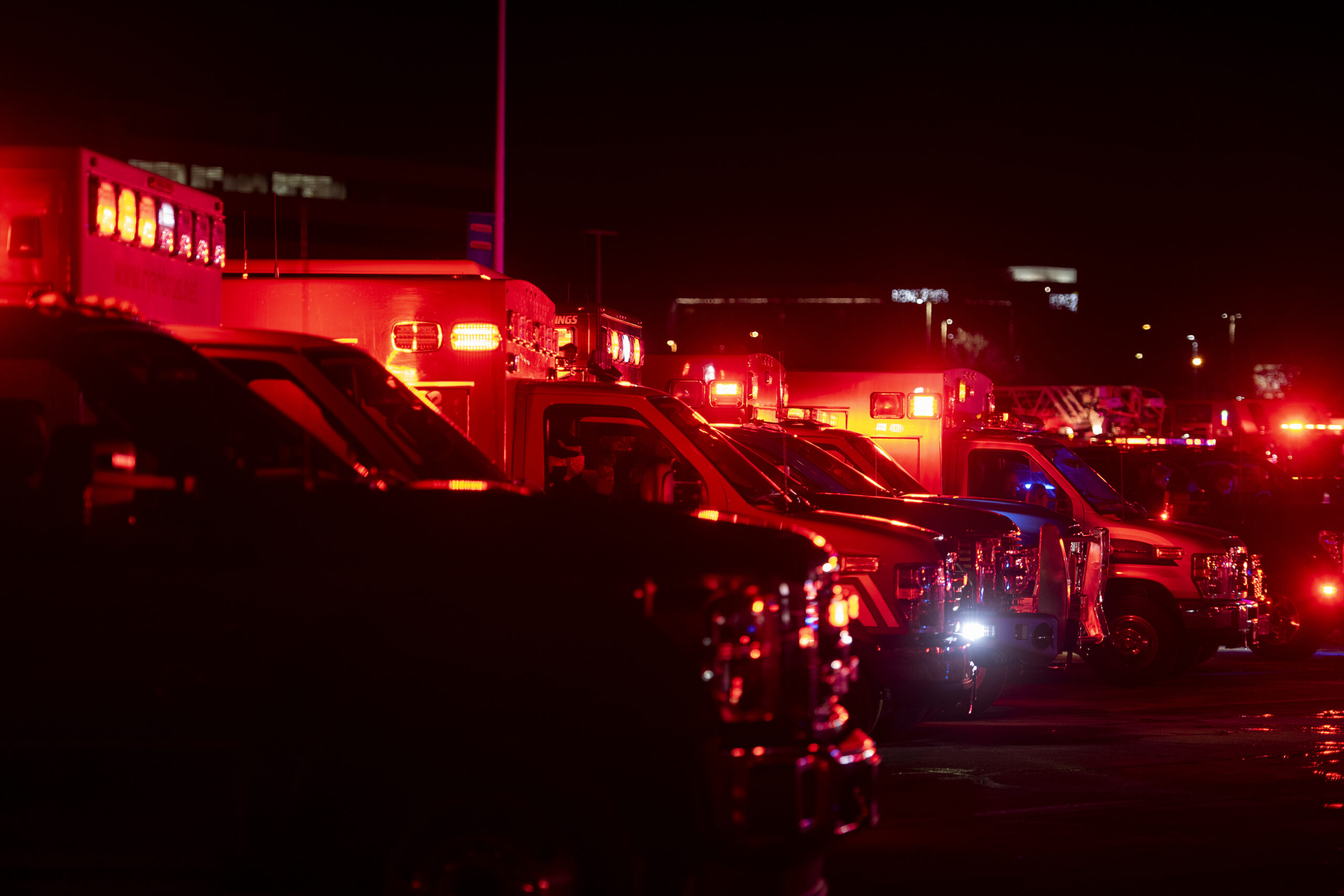 Ambulances glow with red light.