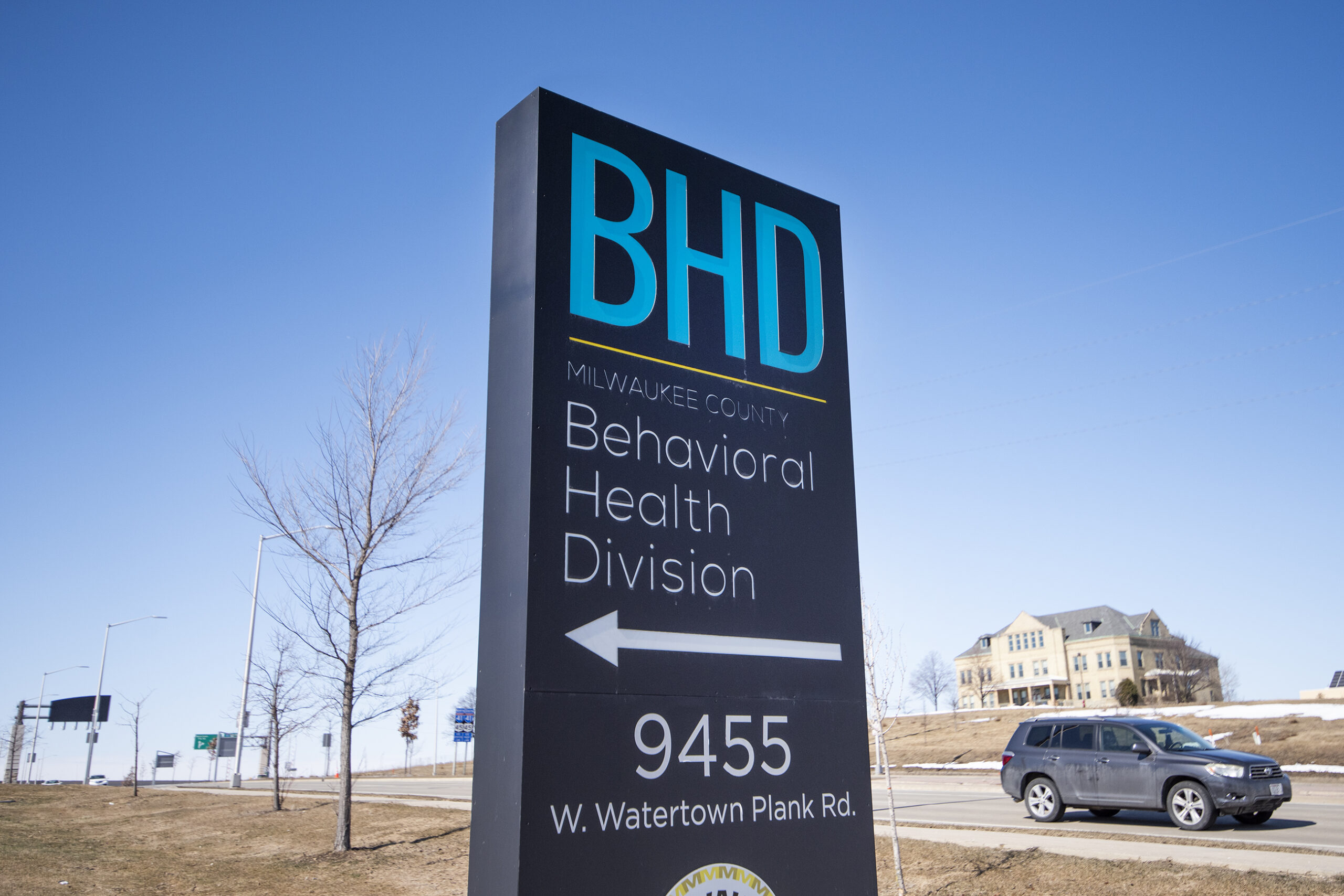 "BHD" in blue text are written on a sign backdropped by a blue sky.