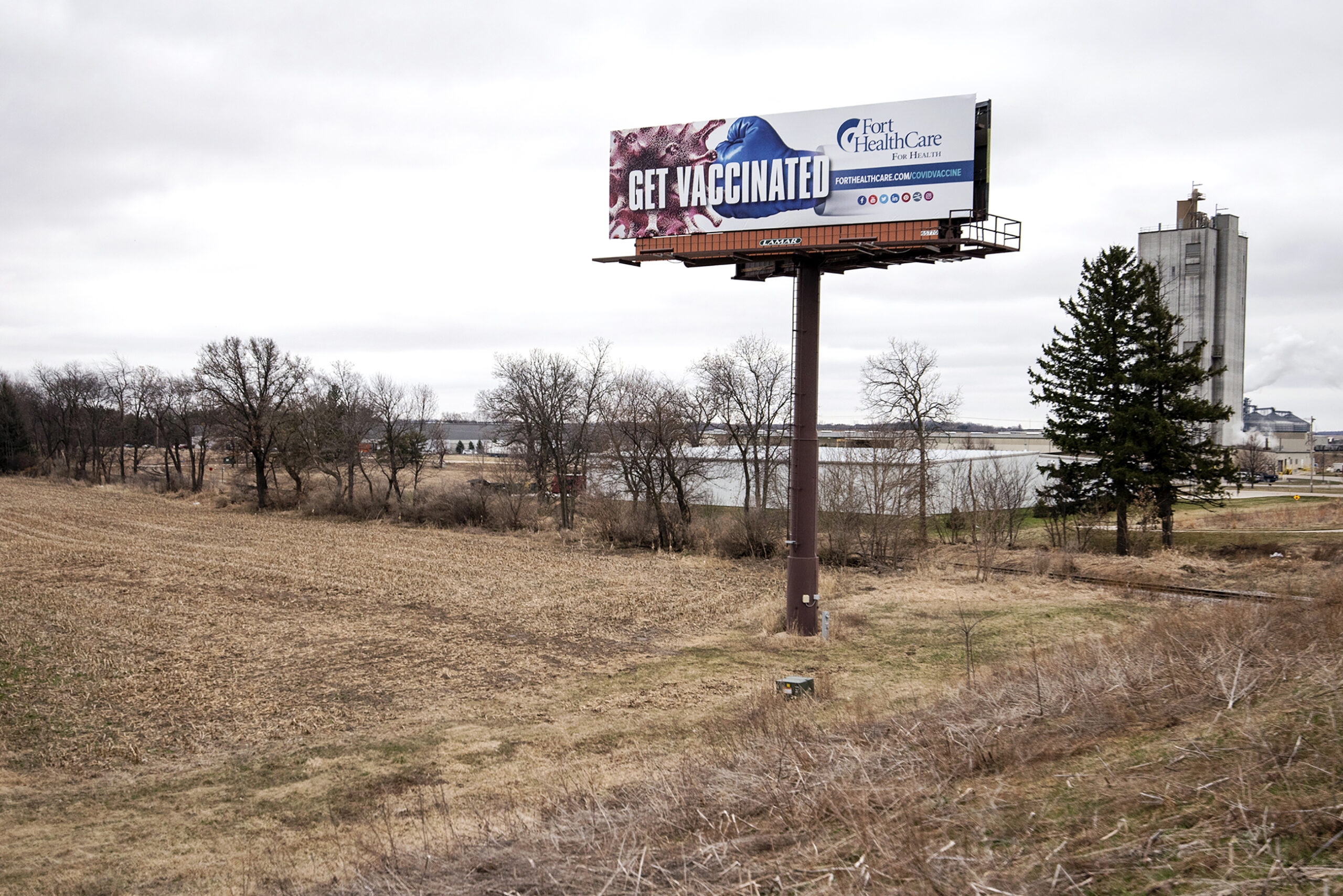 A billboard shows the words "Get Vaccinated."