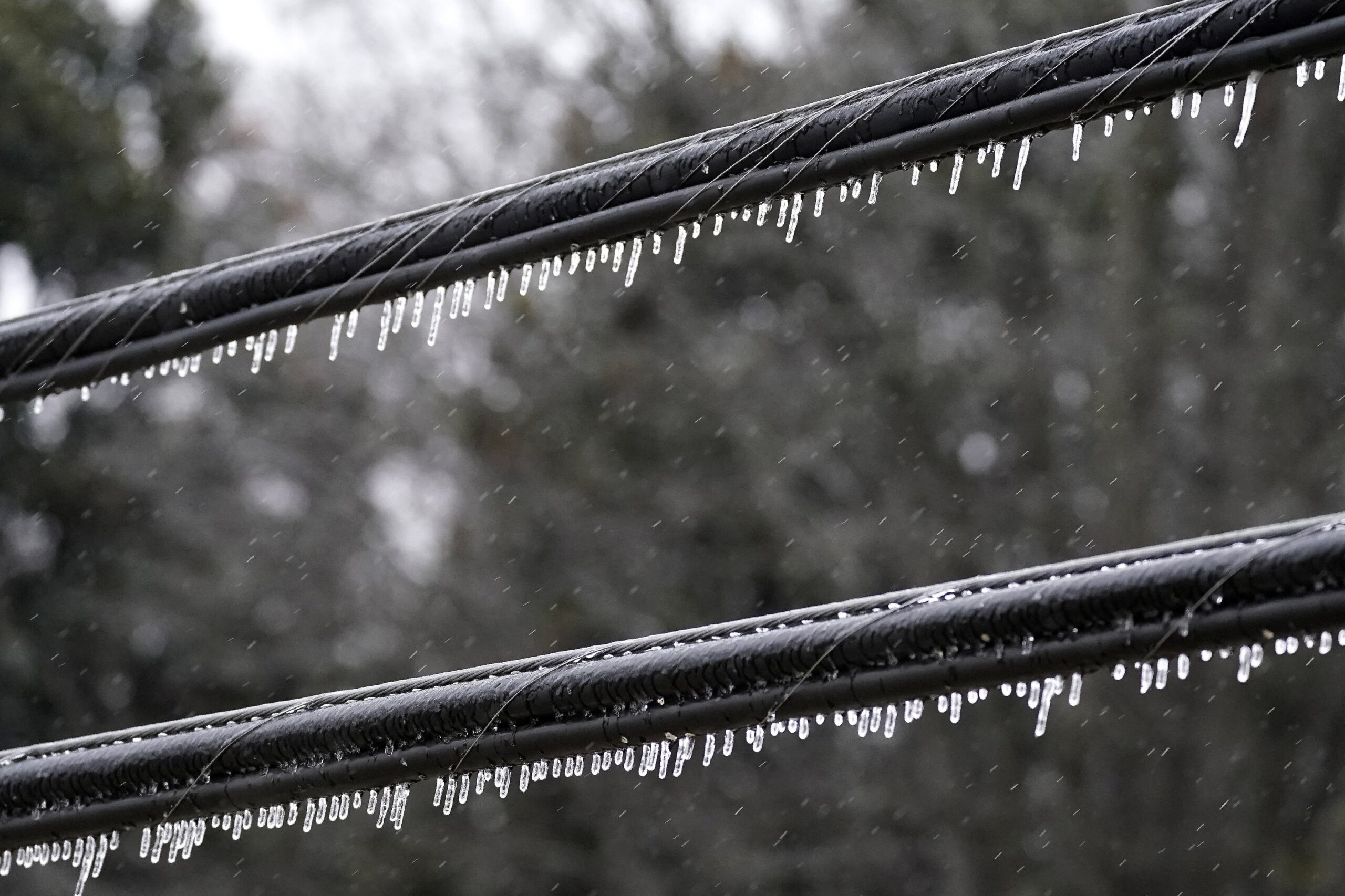Ice forms on power lines as freezing rain accumulates