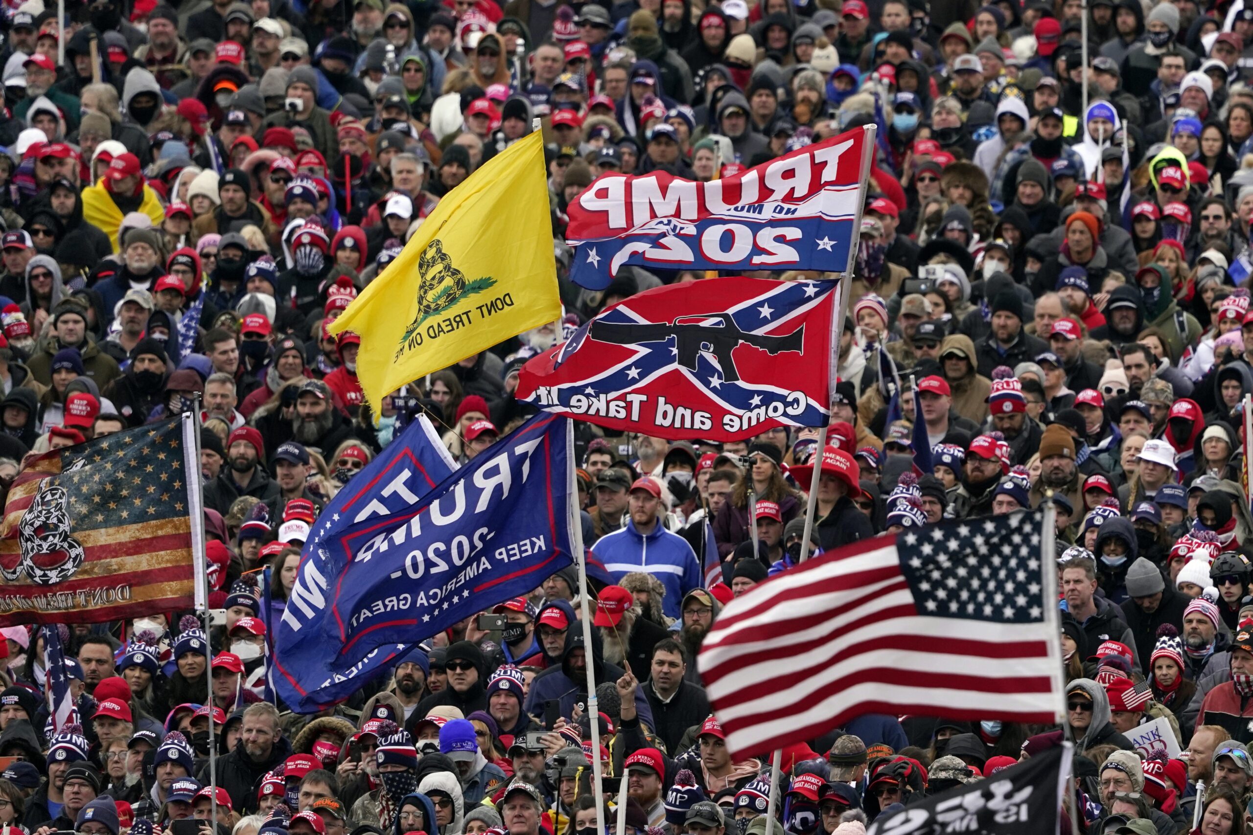 supporters listen as President Donald Trump speaks during a rally in Washington