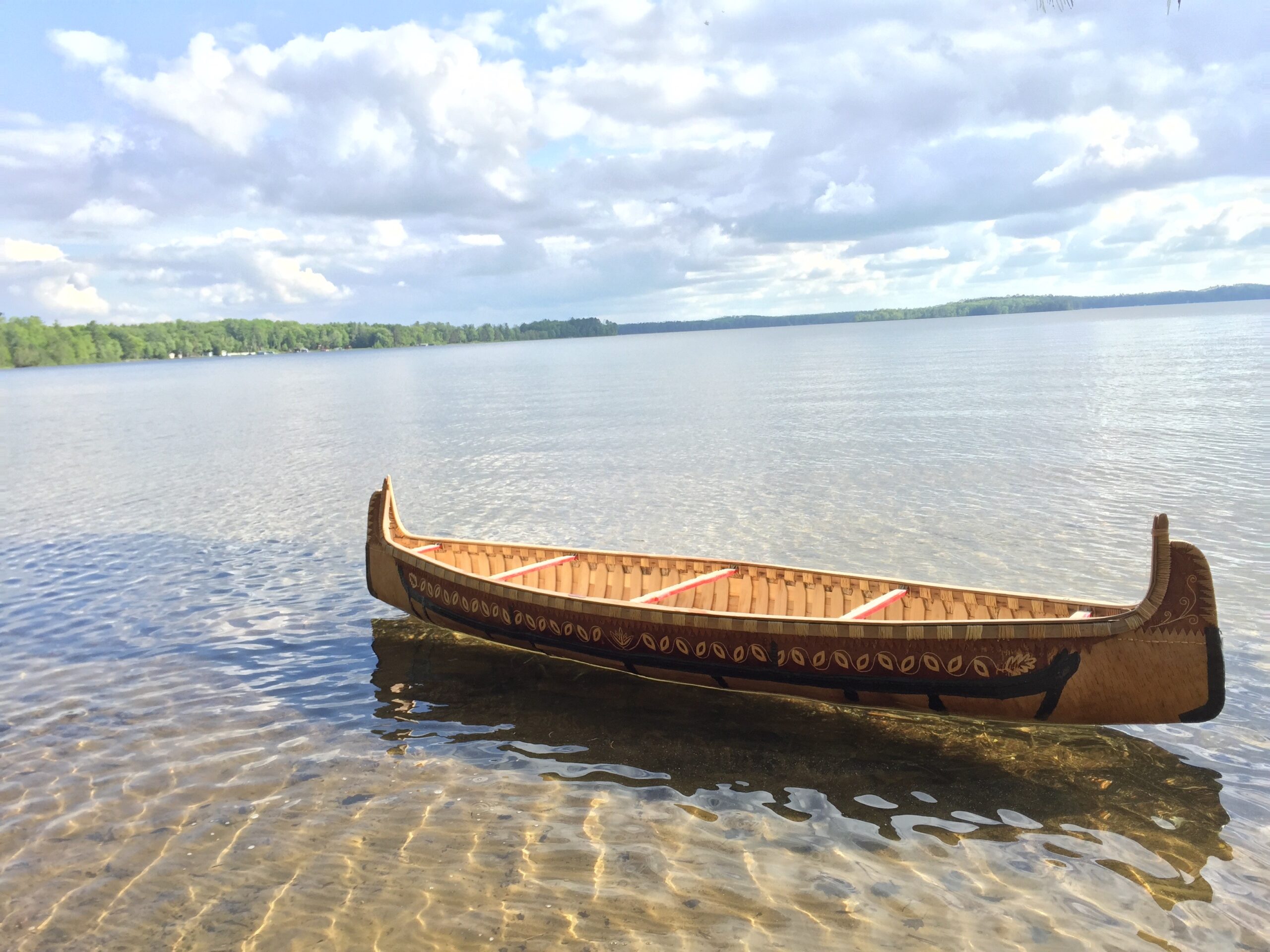 A birchbark canoe built by Wayne Valliere floats in the water