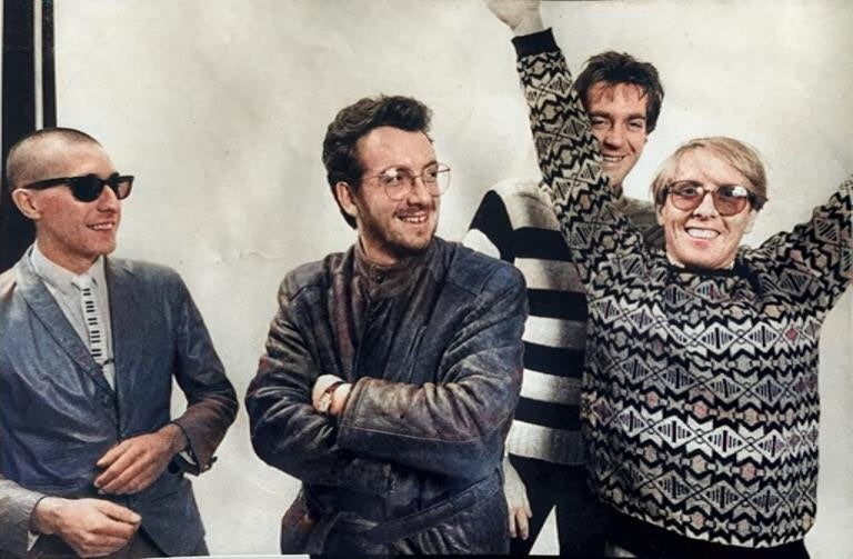 (L to R) Steve Nieve, Elvis Costello, Pete Thomas (in back), Bruce Thomas (arms raised)