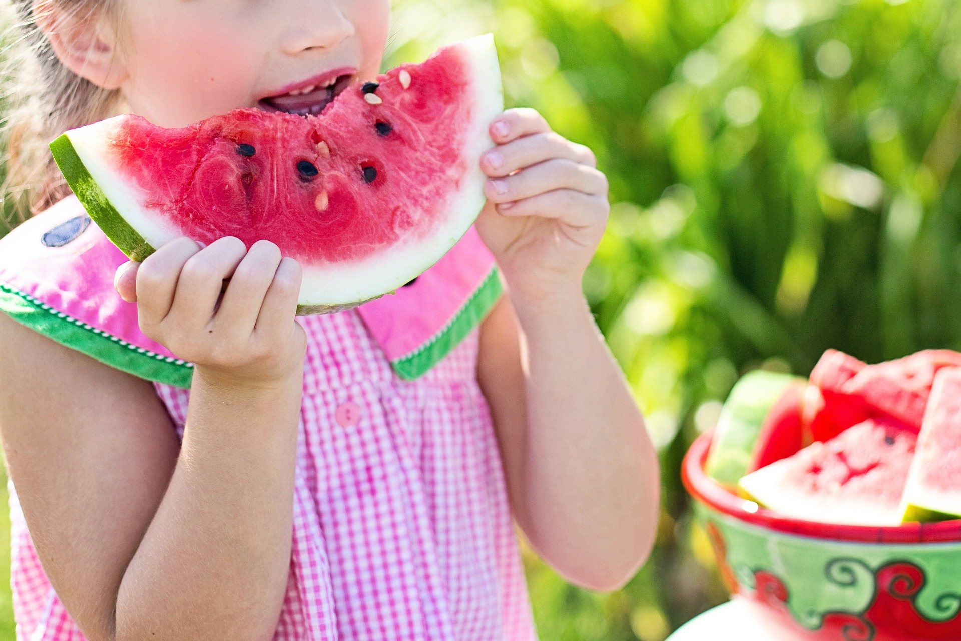 Child eating a slice of watermelon.