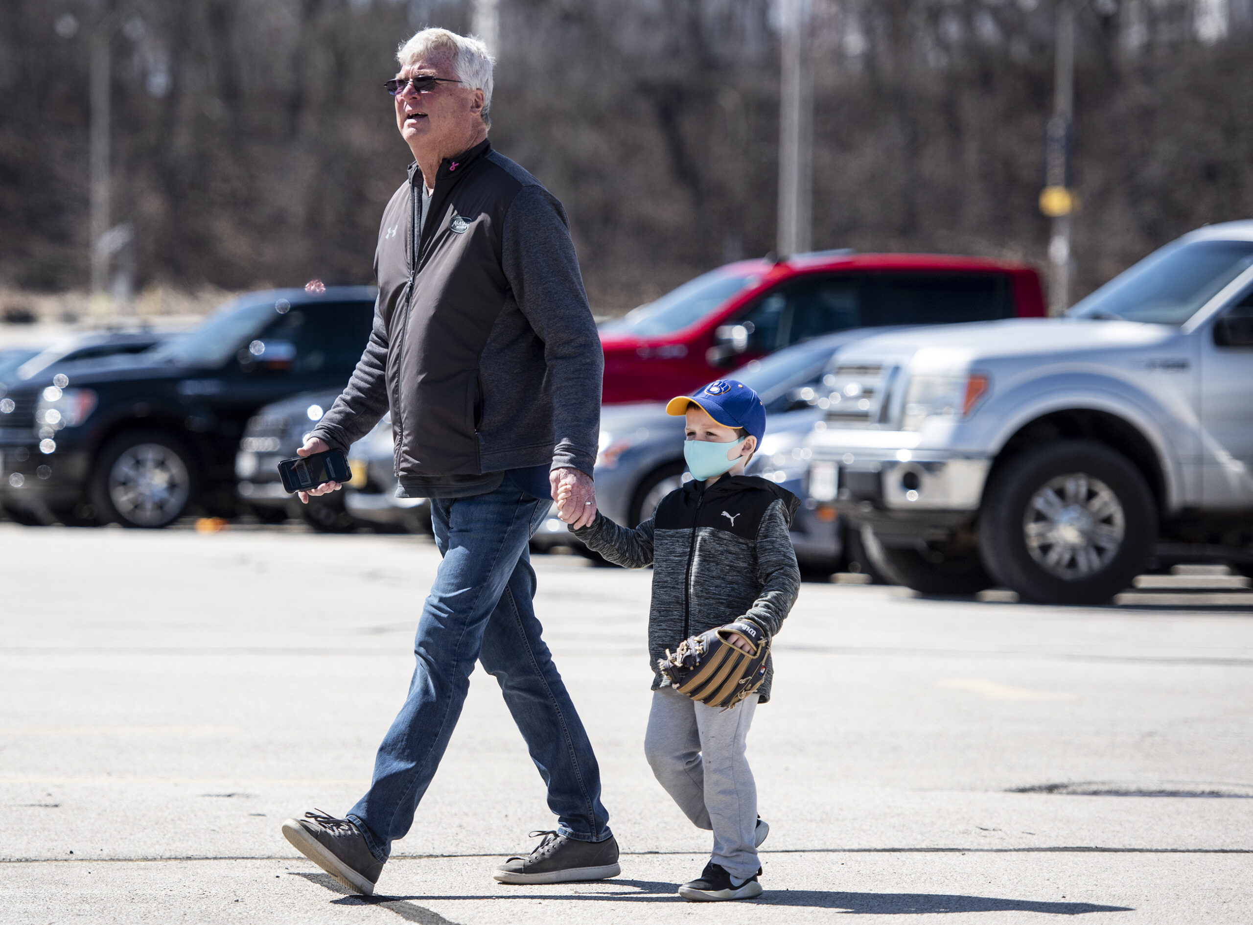 A man and a small boy walk toward the stadium.