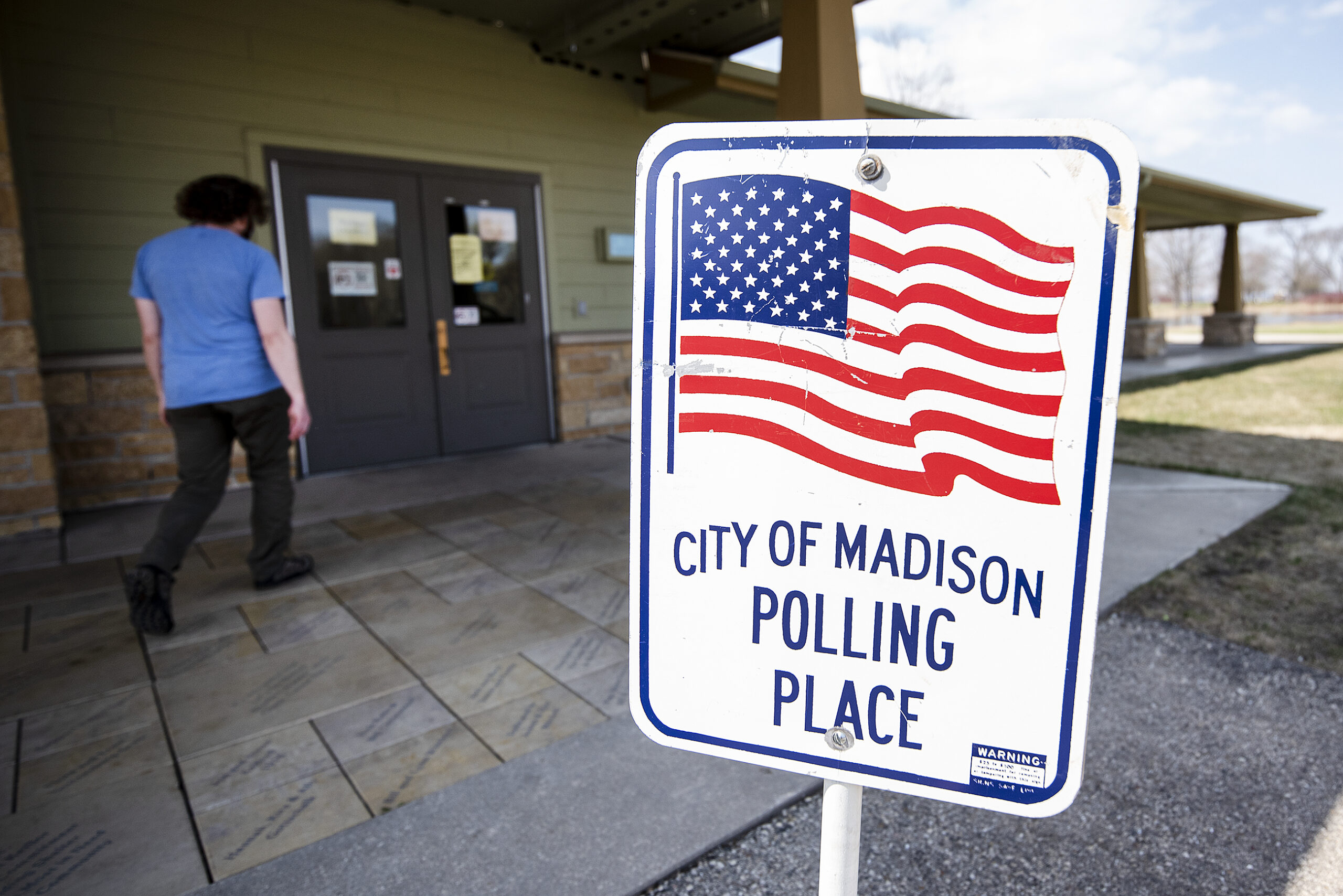 A sign with a U.S. flag says "City of Madison Polling Place."
