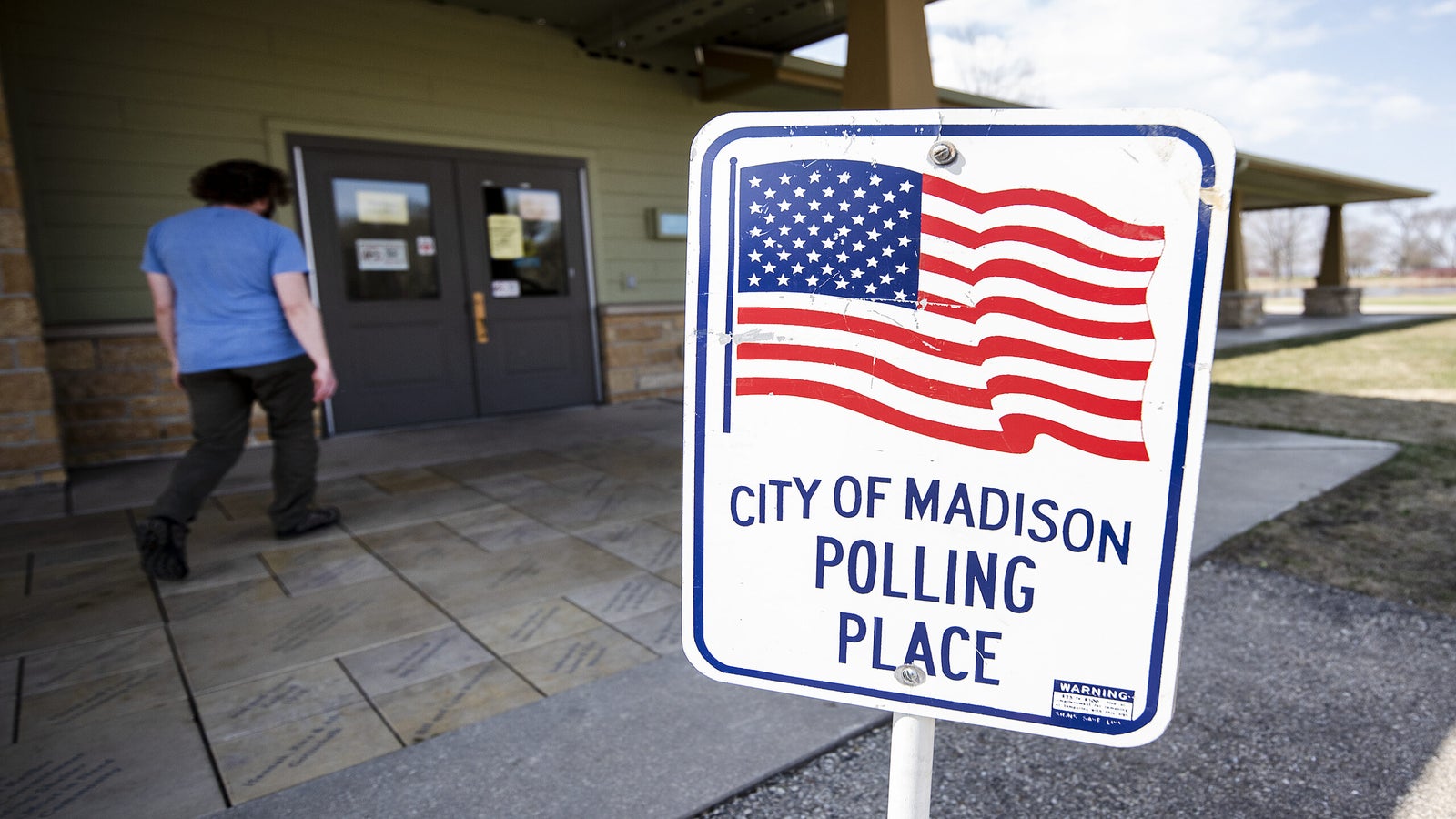 A sign with a U.S. flag says "City of Madison Polling Place."